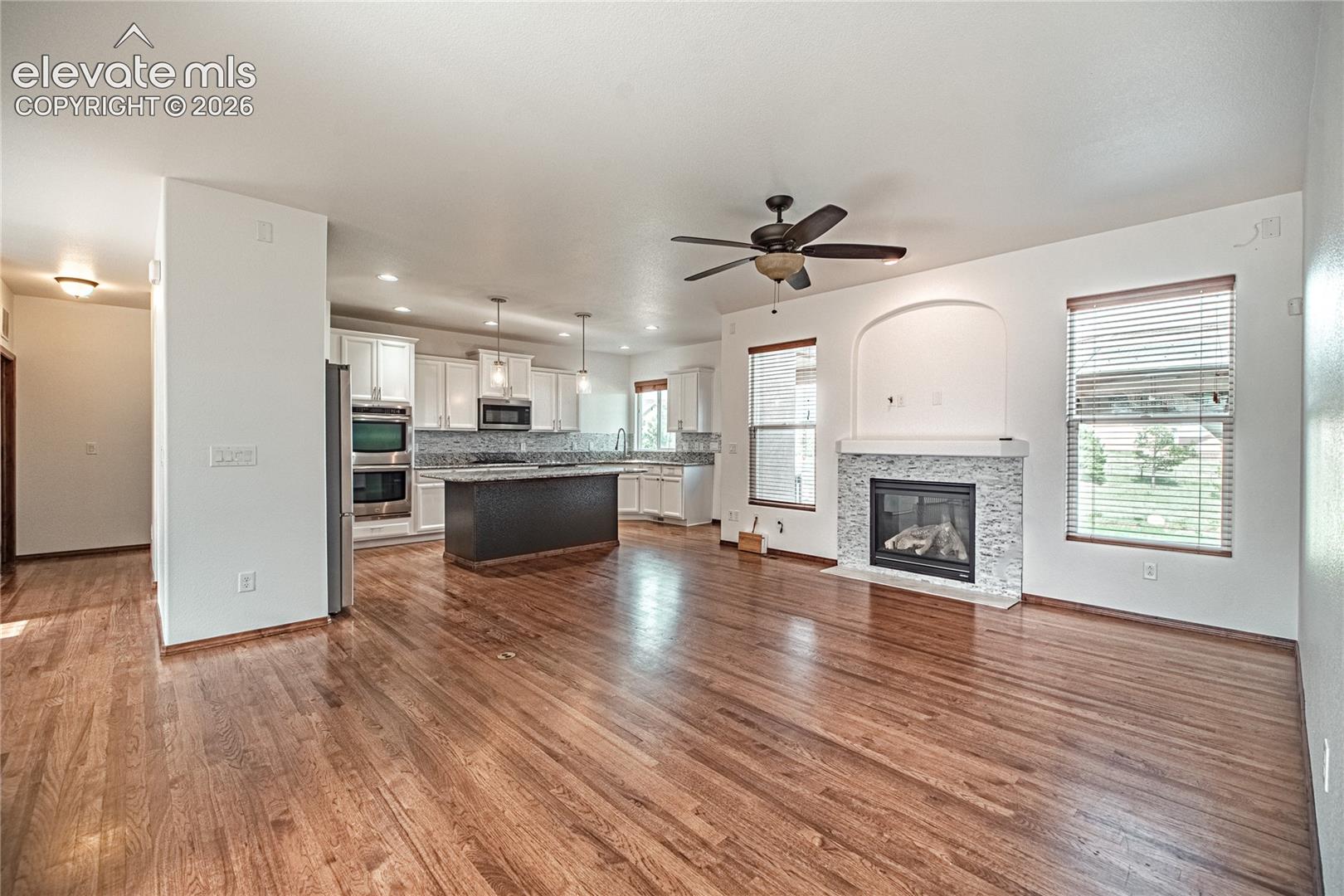 Open-concept living area featuring rich wood-finish flooring