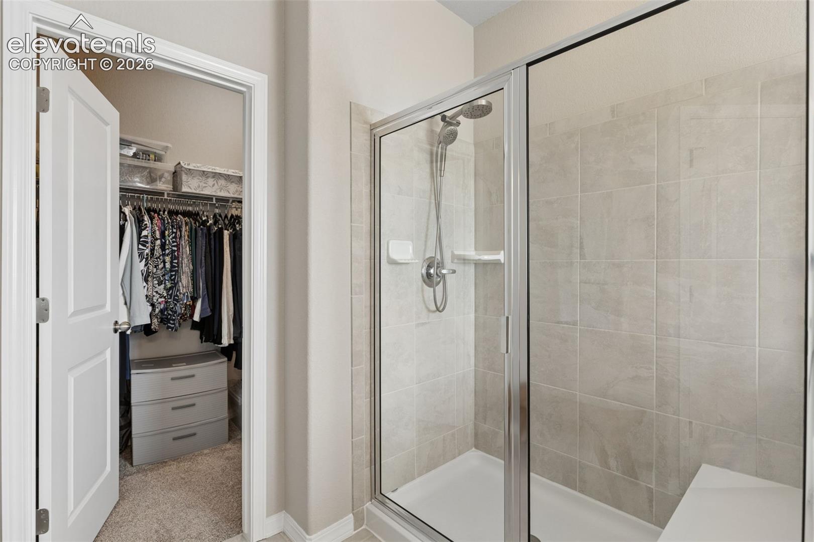 Oversized walk-in shower with bench seat.