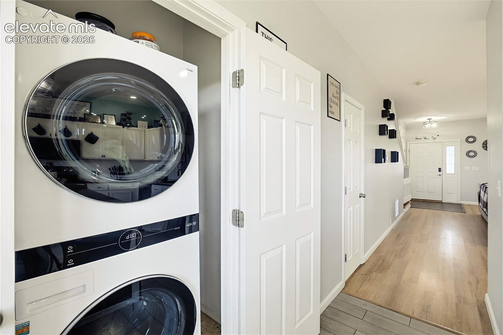 Integrated stacked washer and dryer in a dedicated closet