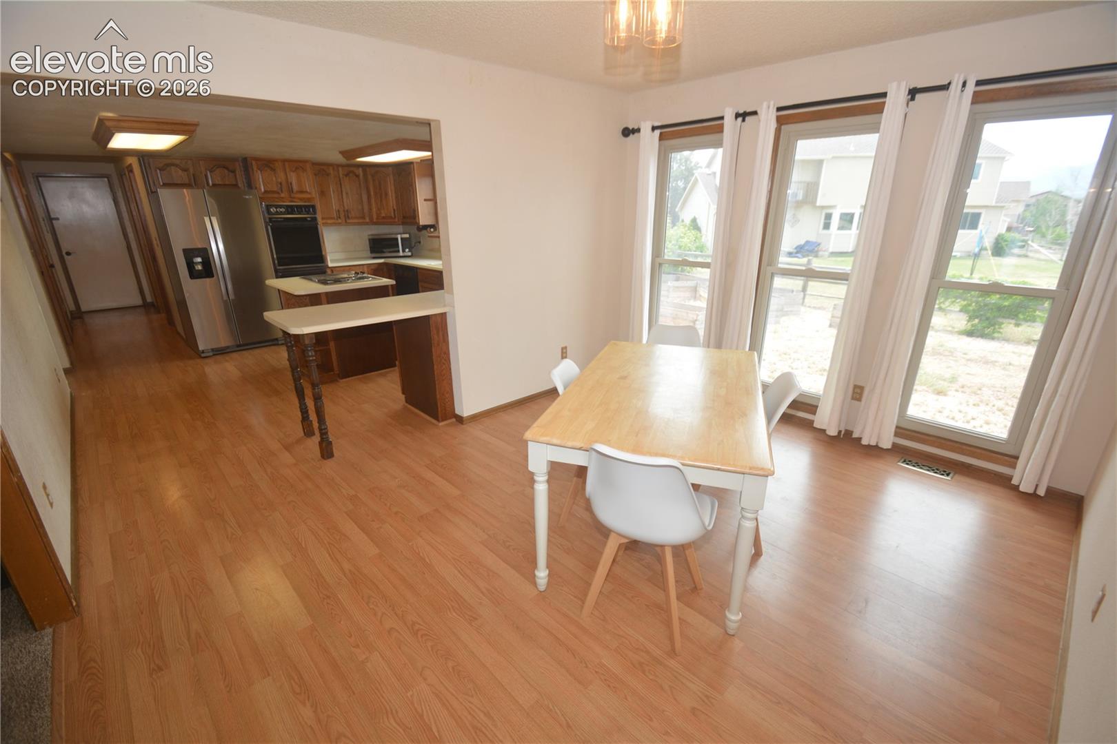 View from Living room into dining room and kitchen