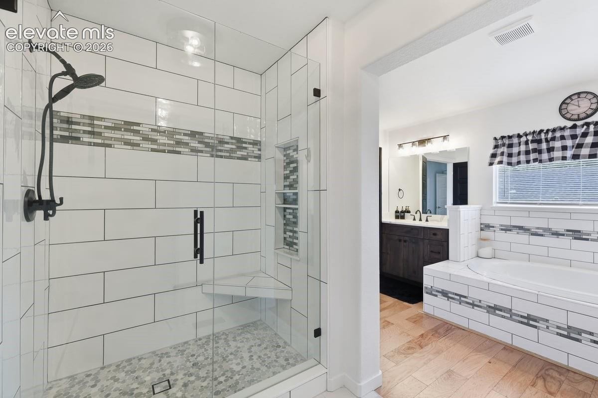 oversized shower with custom tile accents and built-ins