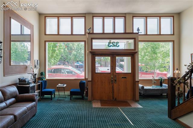 Carpeted entrance foyer with baseboards