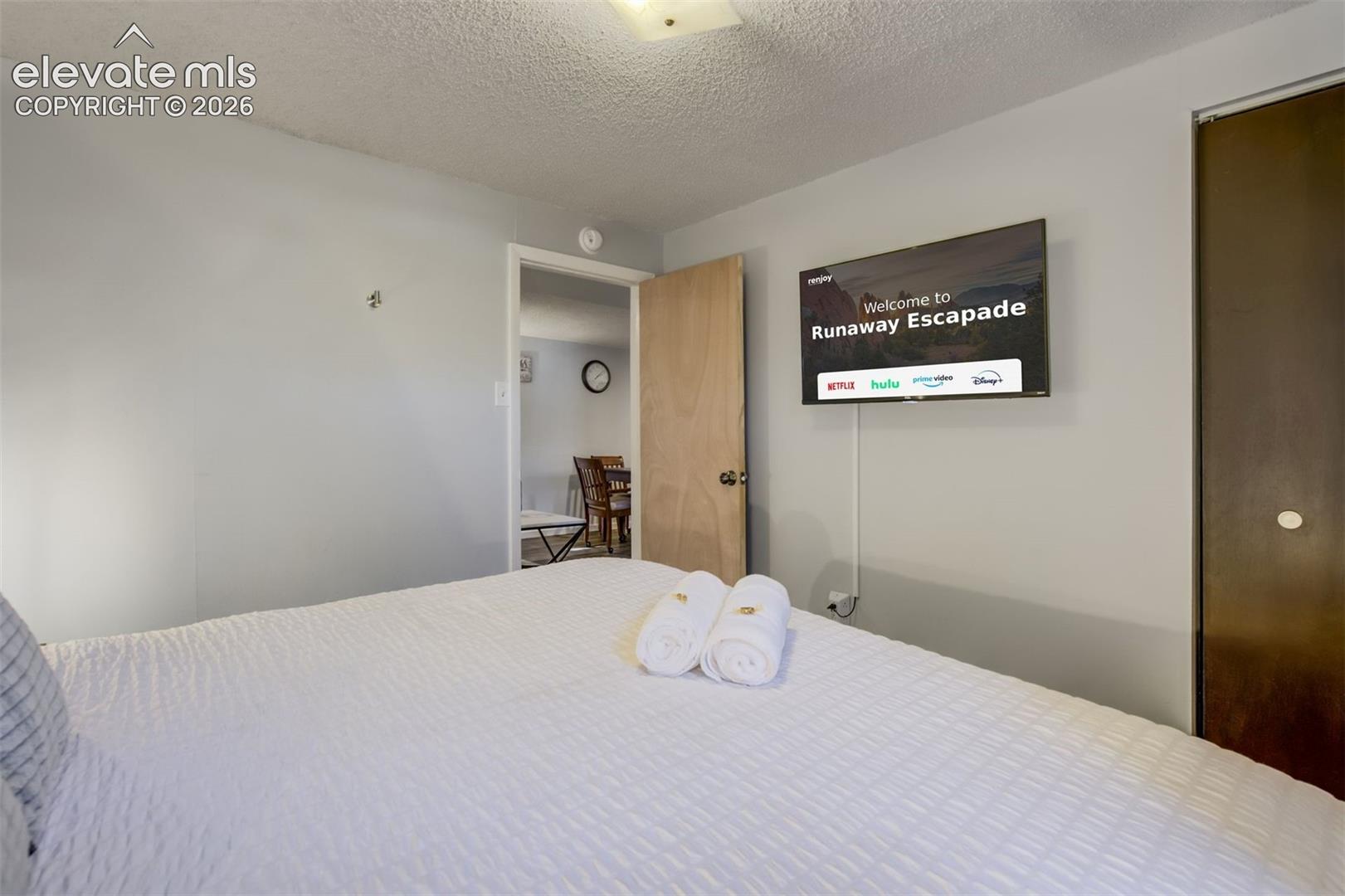 Wall-mounted display, light gray wall finish, and wood-finish door