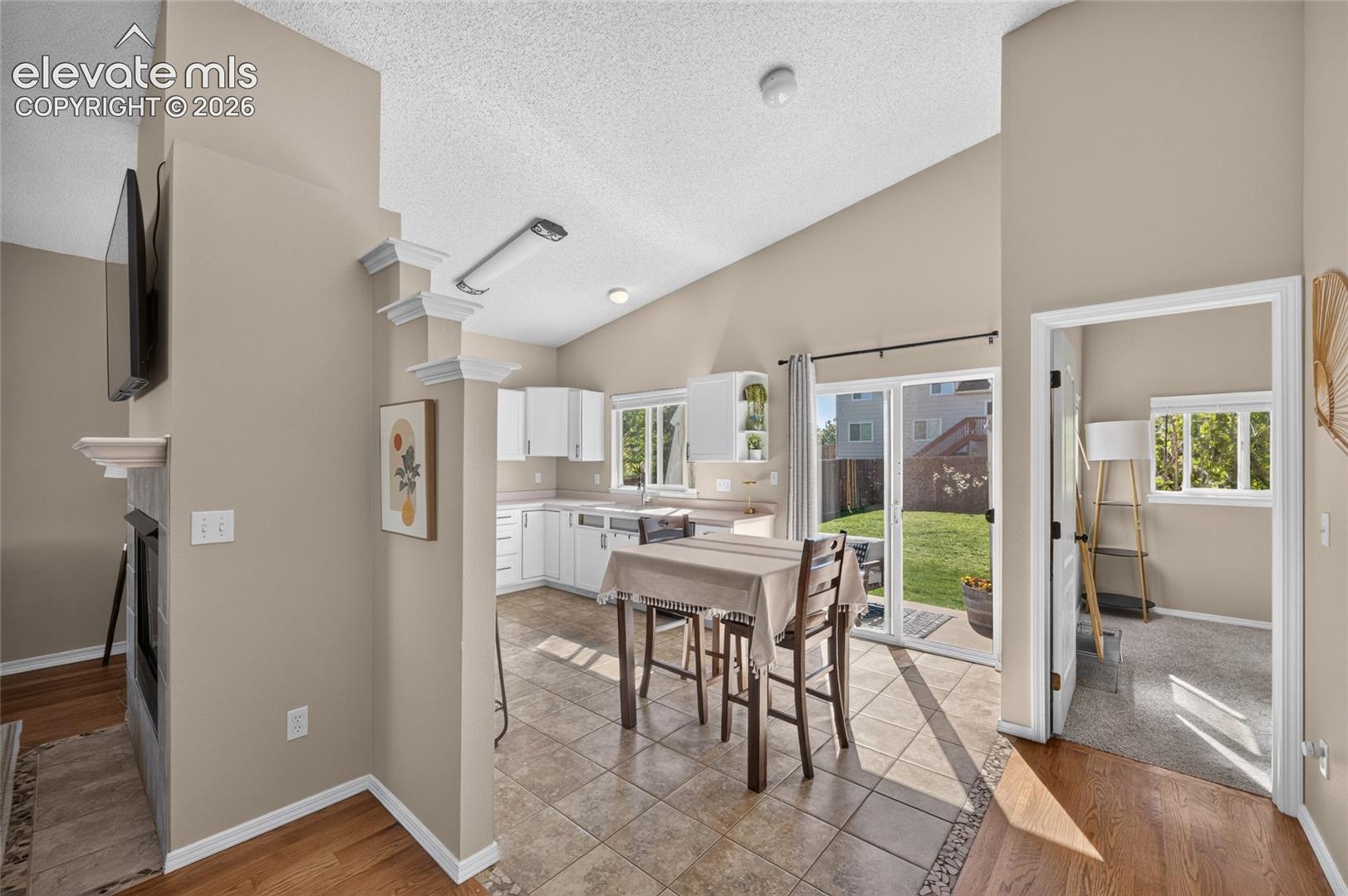 Dining area with slider to the backyard, primary suite just off the main living space
