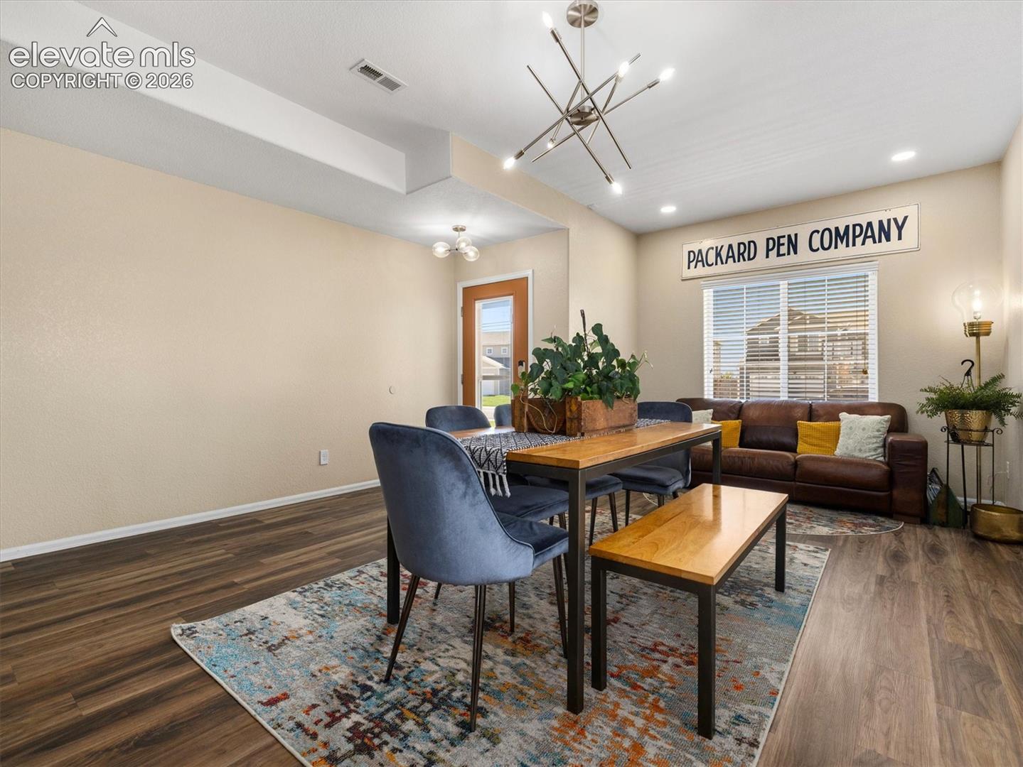 LVP Wood-look flooring, contemporary chandelier, recessed lighting.