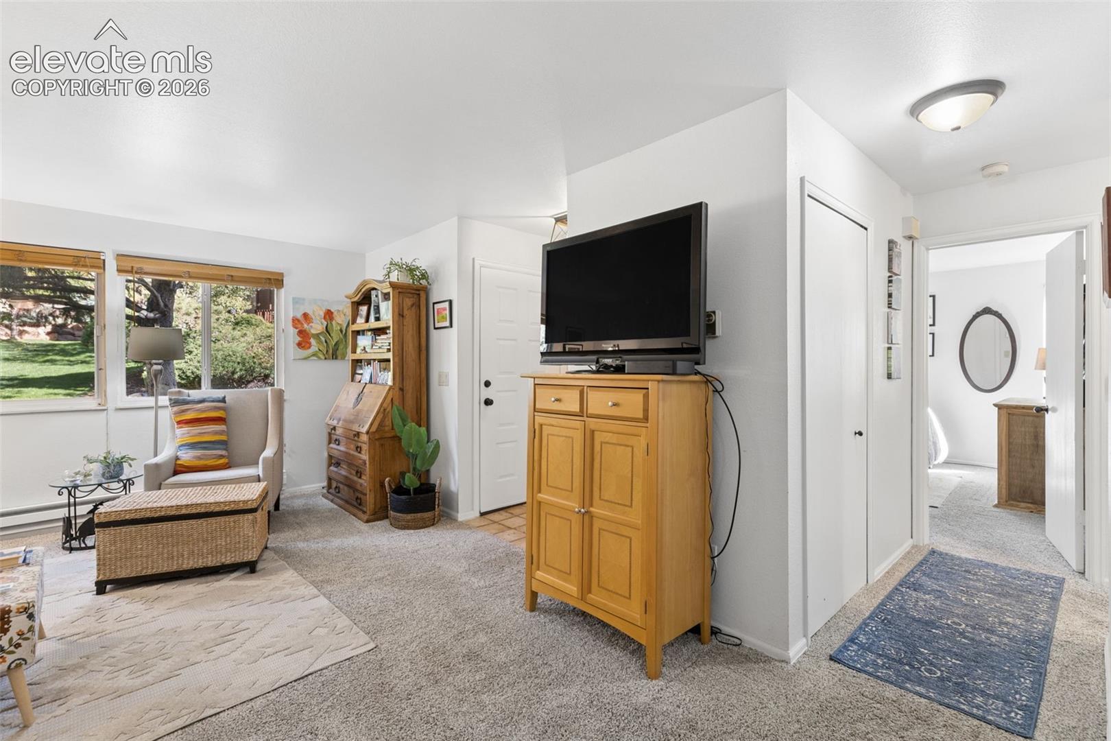Recessed lighting, large windows, wall-to-wall carpeting, and a built-in shelf