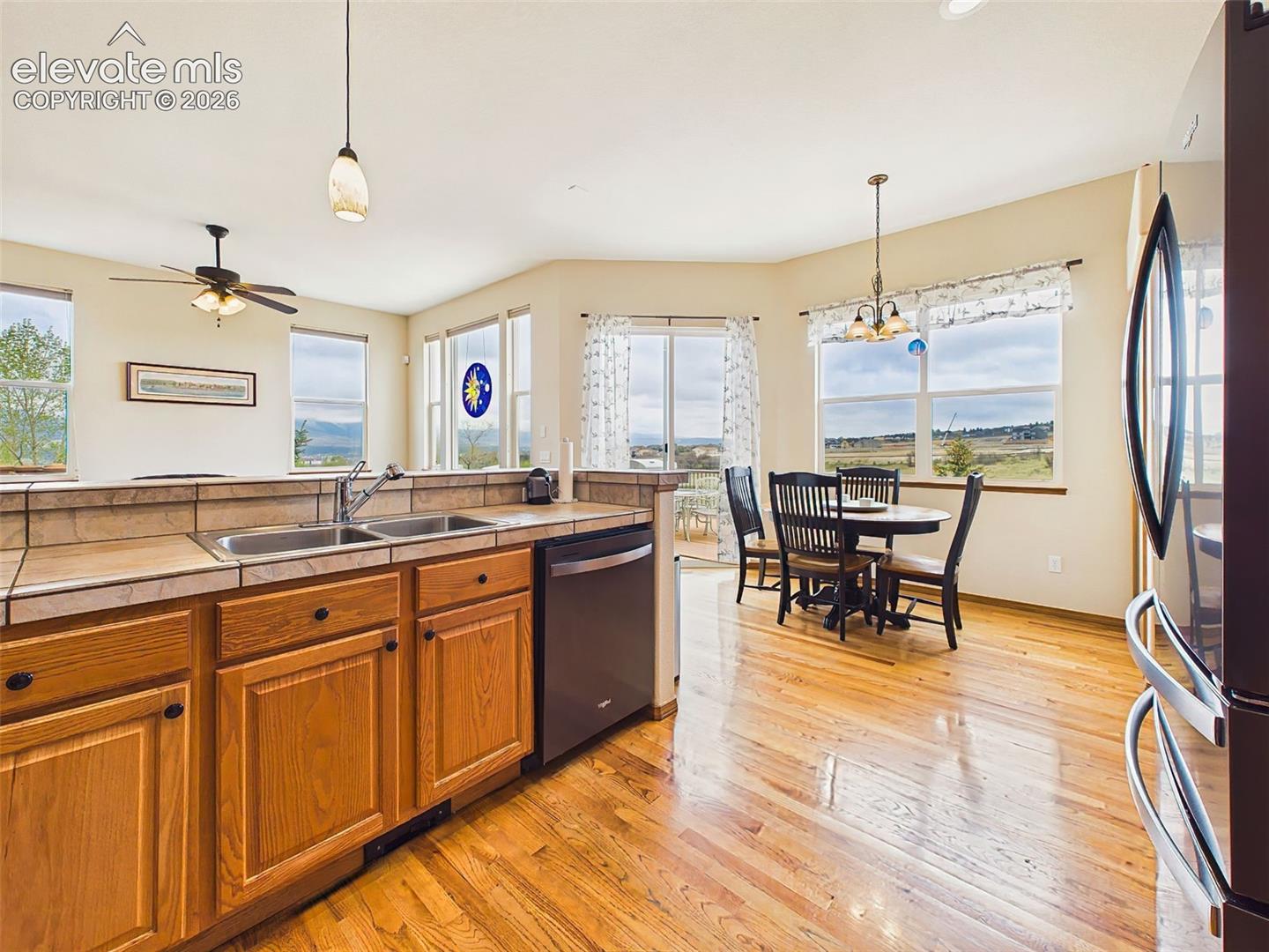Spacious kitchen layout with extensive counter space, hardwood flooring, and an open design ideal for entertaining.