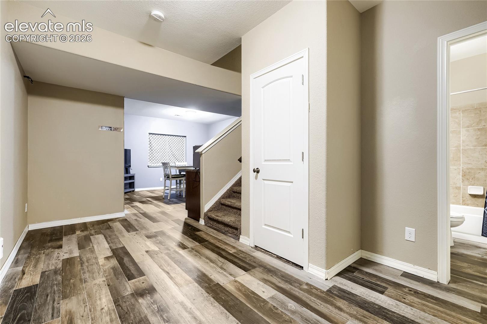 Basement foyer with understairs storage 