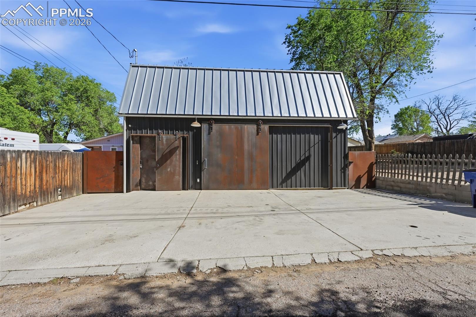10 x 10 custom metal access door to the workshop, and independent accesses to the apartment and rear yard. 3+ paved off street parking. 