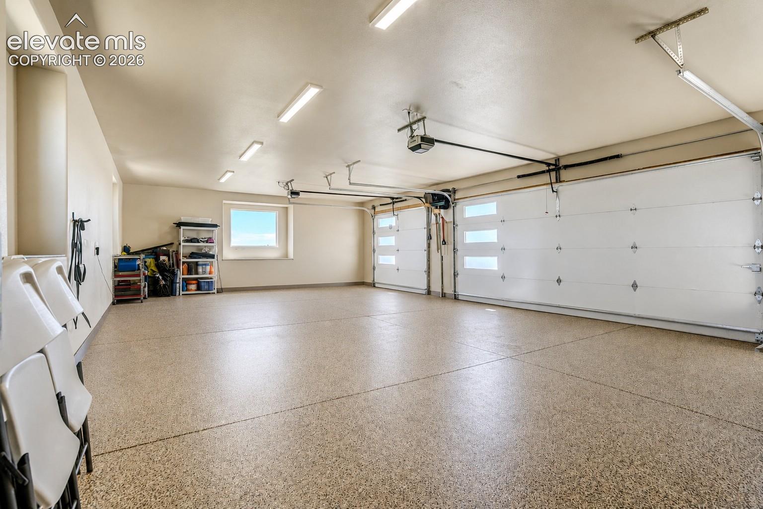 3 car attached upper garage with epoxy flooring