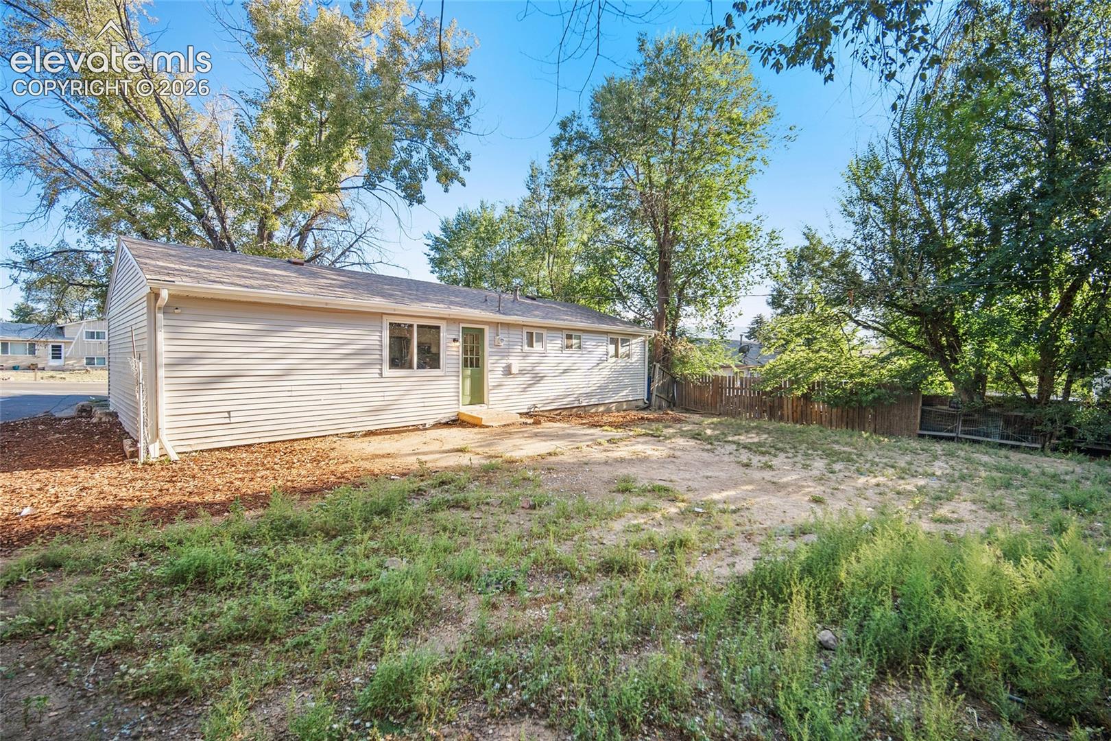 Rear exterior with horizontal siding and multiple windows