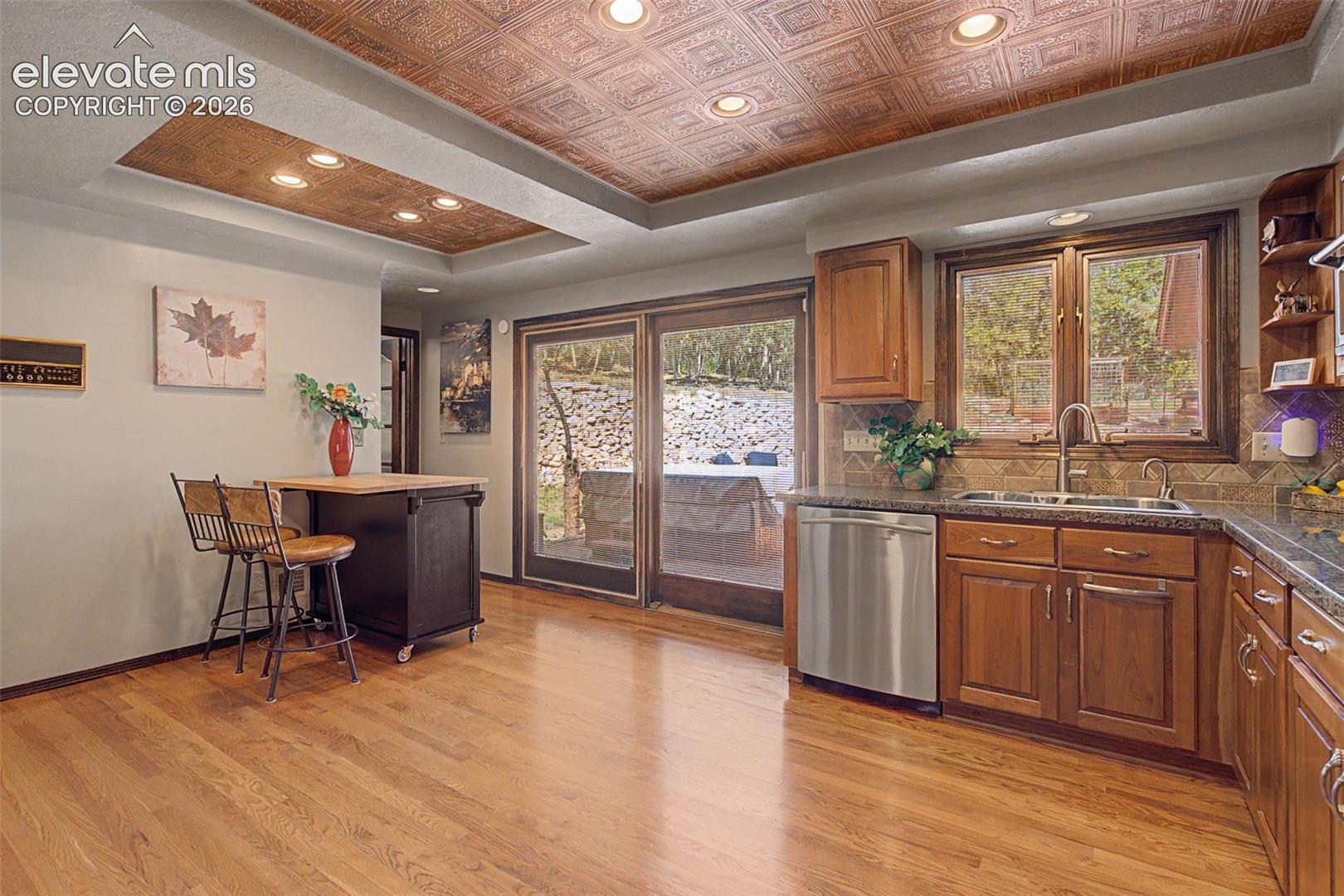 Easy access to rear patio from the kitchen. A perfect place for al fresco dining in the evening while looking at the foothills views. 