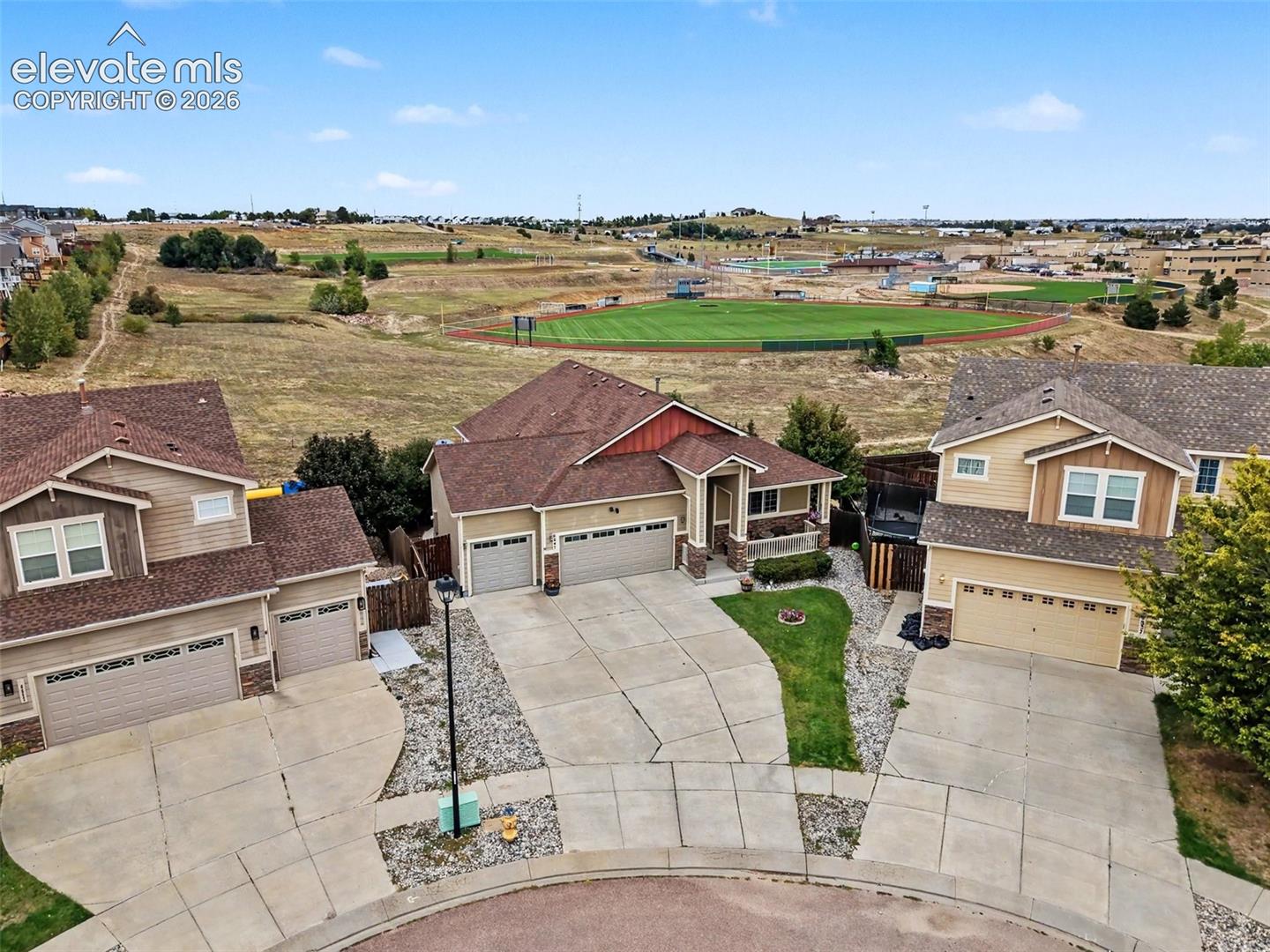 View of the cul-de-sac, front of home, open space and school 