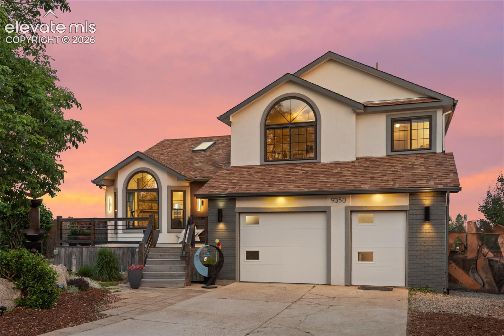 The seller is a designer, architect and artist. That context matters, because this isn't a remodel. It's a decade of someone obsessively building the home they actually wanted to live in. Now it's available. Walk in and the first thing you notice is the staircase. Custom floating steel and wood, skylights overhead, vaulted ceiling pulling everything upward. The main level is open, intentional, and finished with real craft: a kitchen island built from reclaimed wood sitting under quartz countertops, open shelving, stainless appliances. It functions as well as it photographs. Step out to the upper deck and you get mountain and city views that genuinely earn the word. The primary suite is the room people are going to talk about. Wood-paneled ceiling, corrugated metal details, custom barn doors, and a loft above accessed by a ship's ladder. The en suite matches: freestanding soaking tub in front of a picture window with mountain views, glass walk-in shower, dual vanity with custom tile. Nothing about it is accidental. Downstairs is a fully finished walkout ADU with a private entrance, full kitchen, living room with fireplace, bedroom, bathroom and laundry. Plug-and-play for rental income, in-law setup, or long-term guests. Outside: cul-de-sac lot surrounded by mature aspen and pine, multi-level decking, fully fenced yard, dog run and garden space. Two garages. No HOA. Academy 20 all the way through: High Plains, Timberview, Rampart. The seller's sculptural art collection lives throughout the home. Several pieces are available with purchase. Ask for details.
