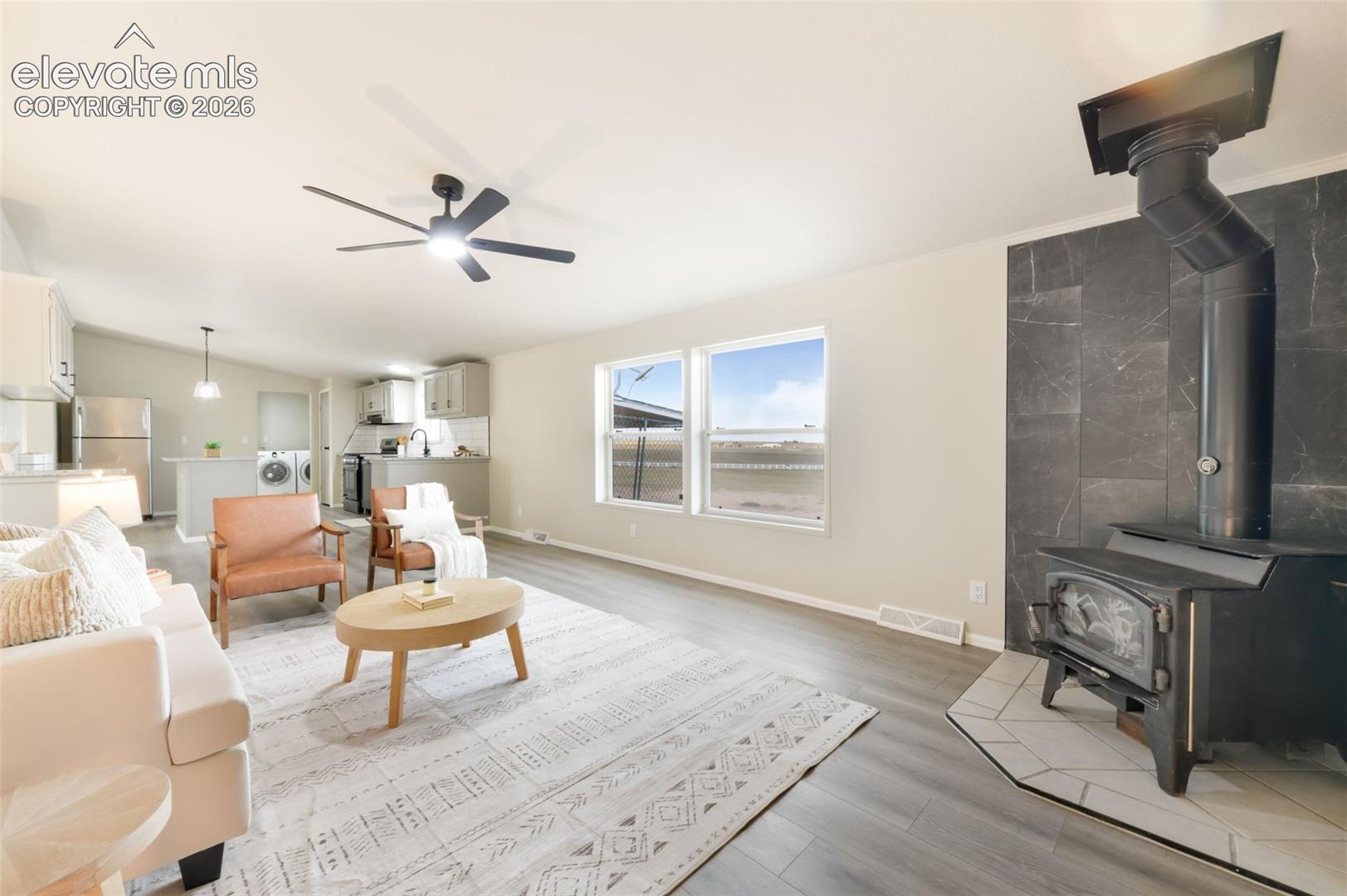 Open concept living area with wood-finish flooring