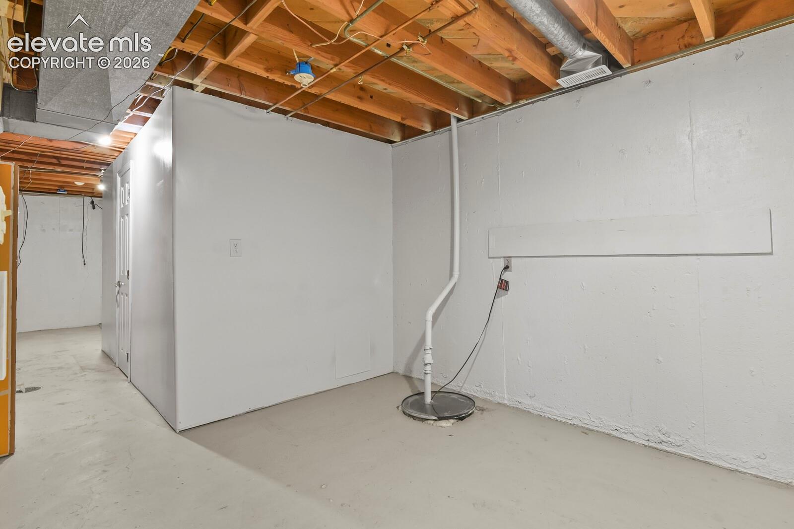 Storage area looking towards laundry area.  Home has existing and functional radon mitigation system.