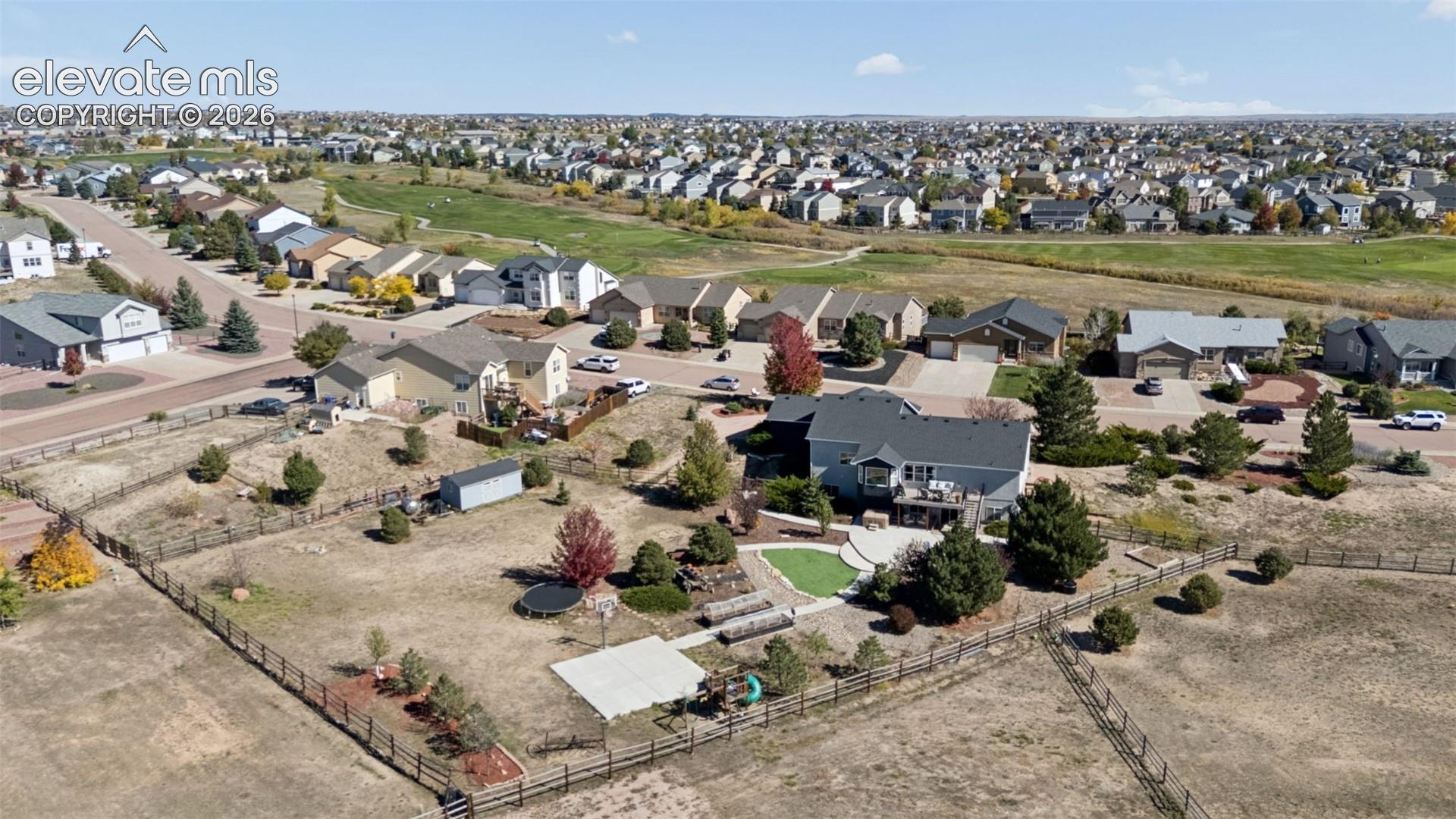 Spacious property featuring an expansive backyard, fenced perimeter, and a detached storage shed