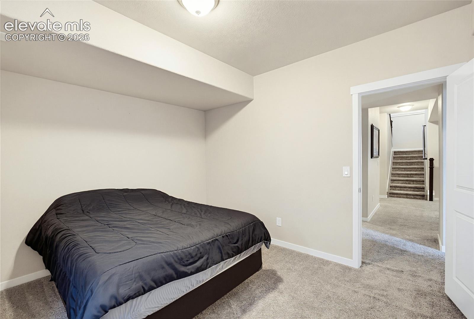 Neutral interior featuring carpeted flooring and a recessed alcove