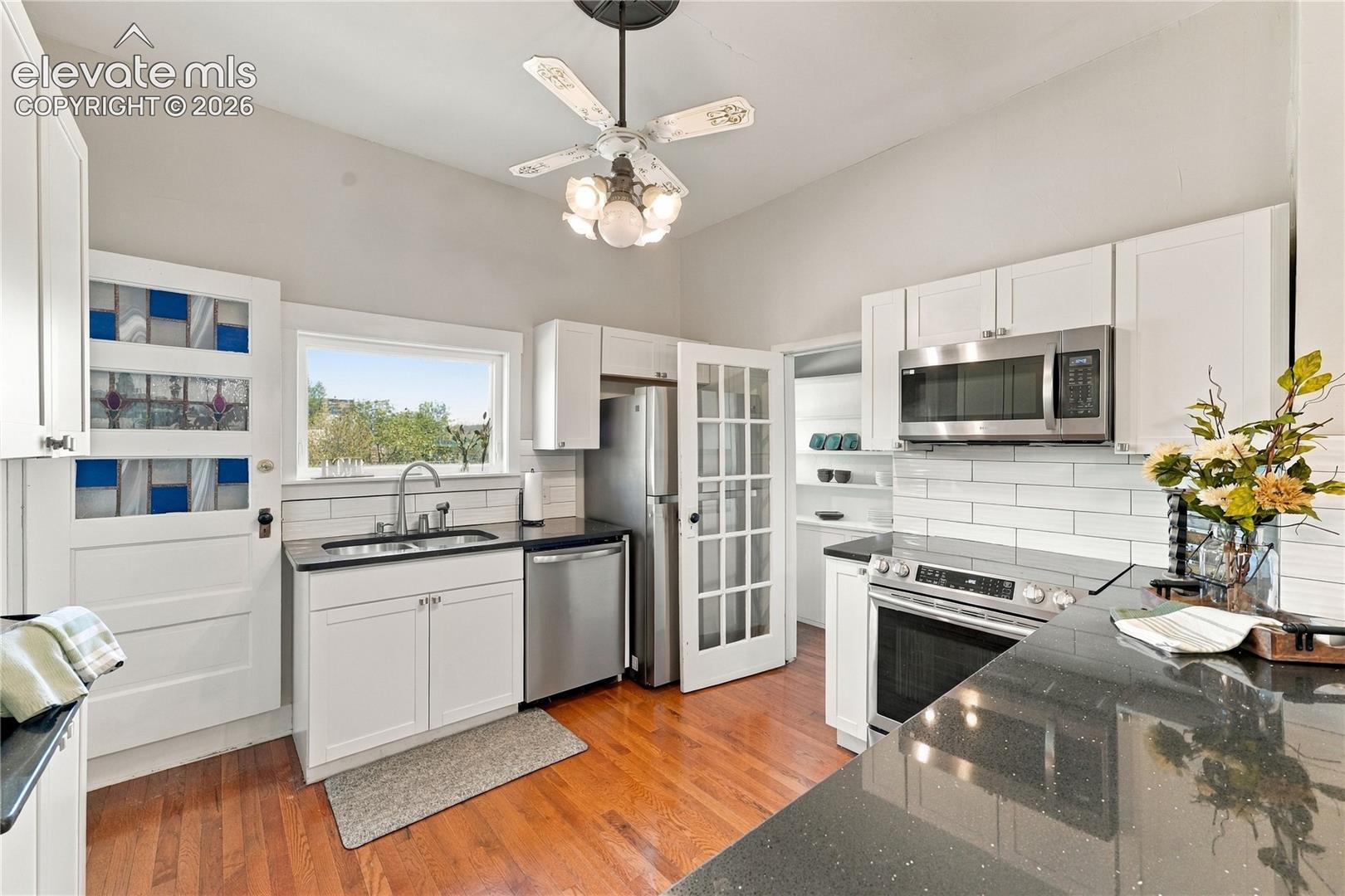 Primary kitchen on main, with updated appliances, solid surface counters and bar seating