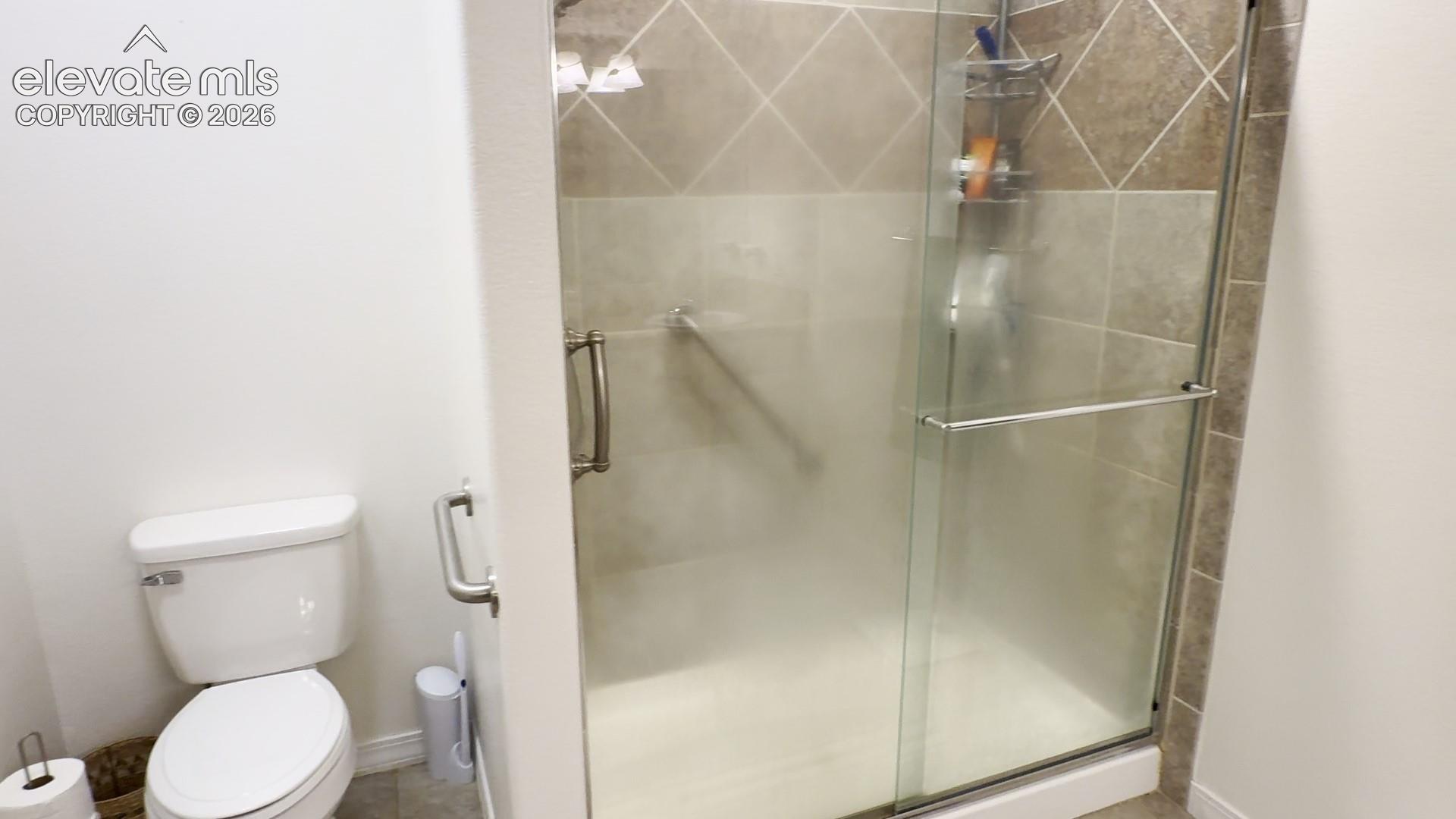 The 2nd Primary bathroom shows the oversized tiled shower with hand rails, if needed