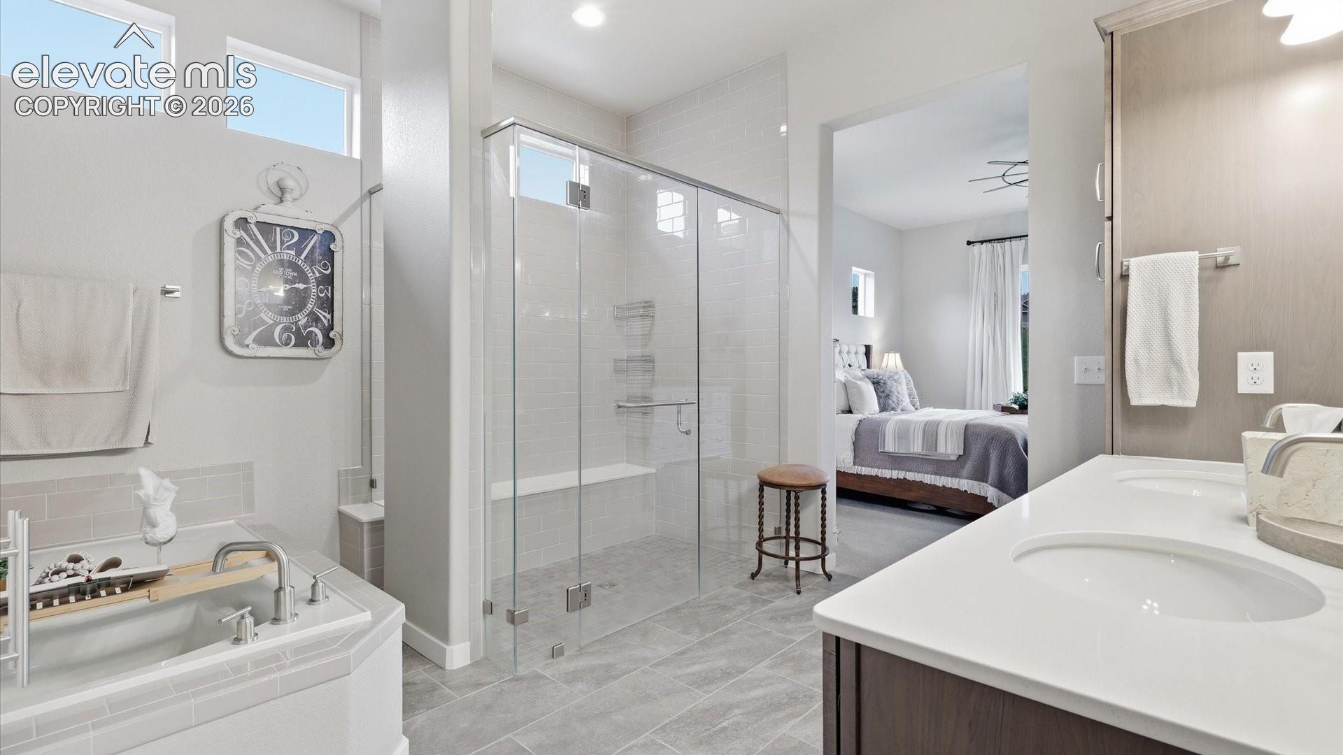 A SANCTUARY AT HOME — This elegant primary bath offers a tranquil setting to begin and end each day surrounded by comfort and sophistication.