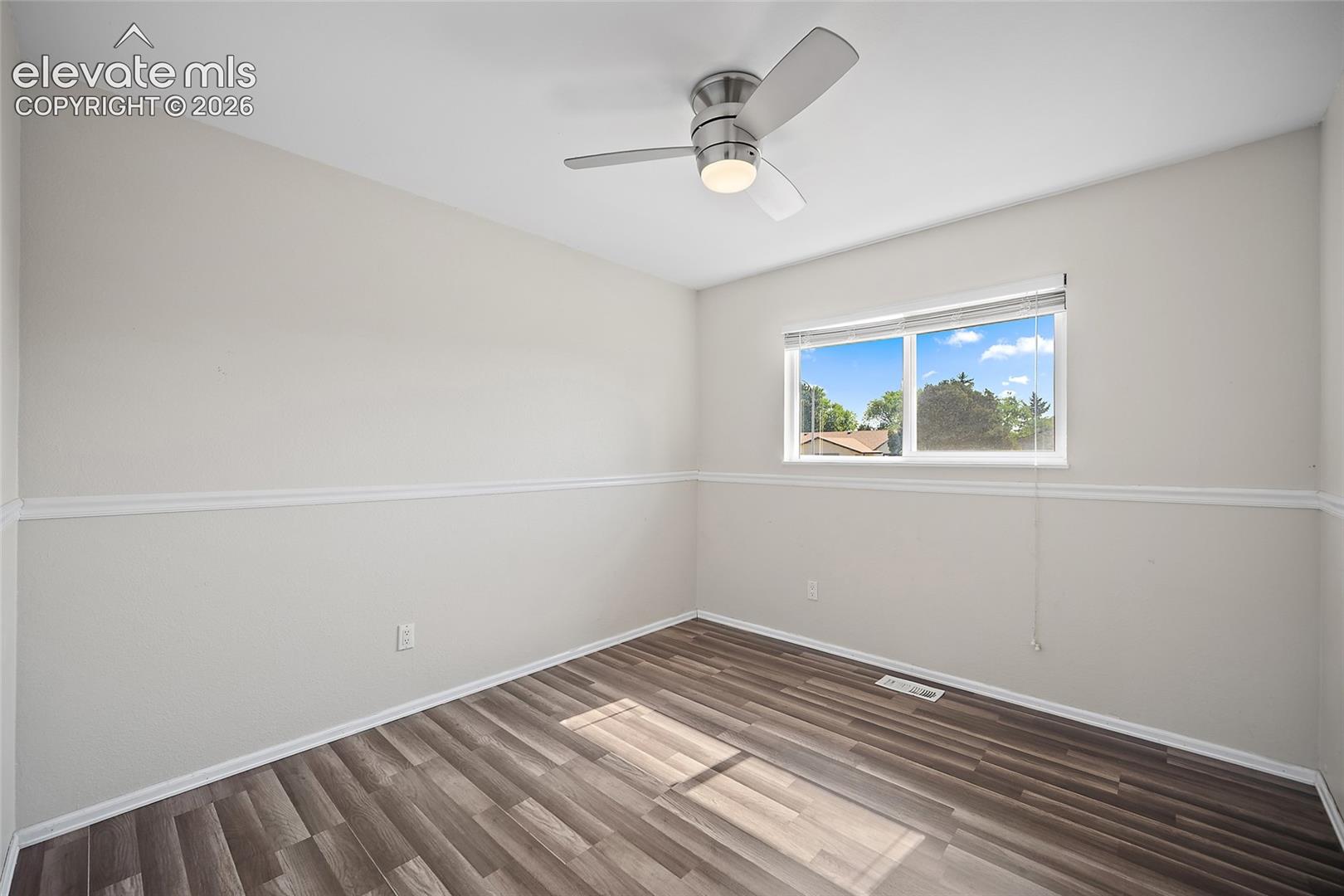 Bedroom with views of mature trees.