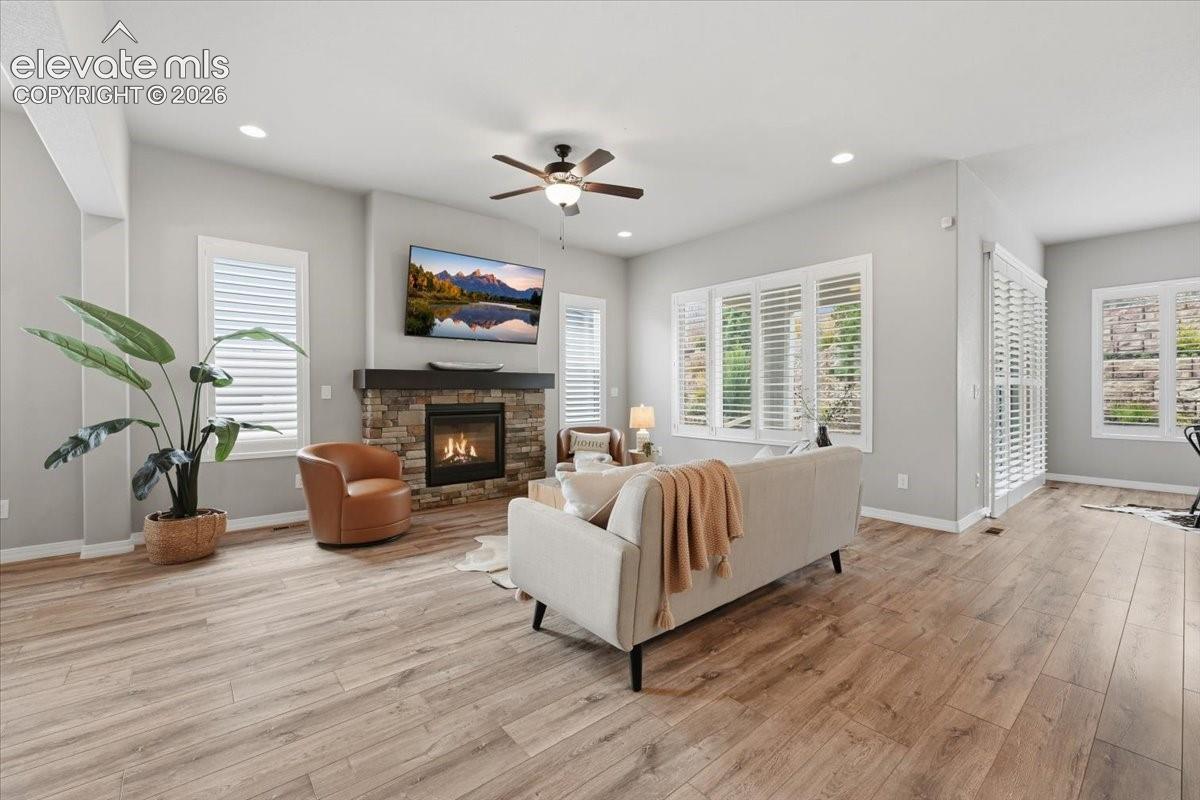 Cozy and spacious great room with fireplace and plantation shutters!