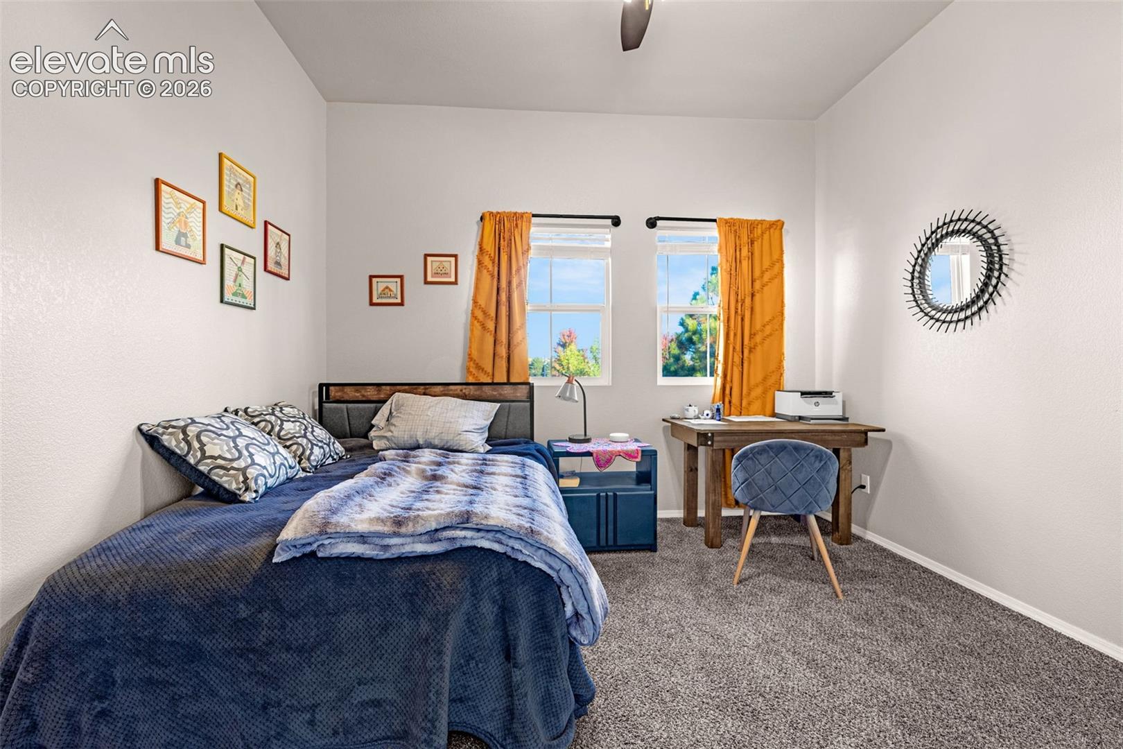 Neutral interior space featuring high ceilings, two double-hung windows, and wall-to-wall carpeting