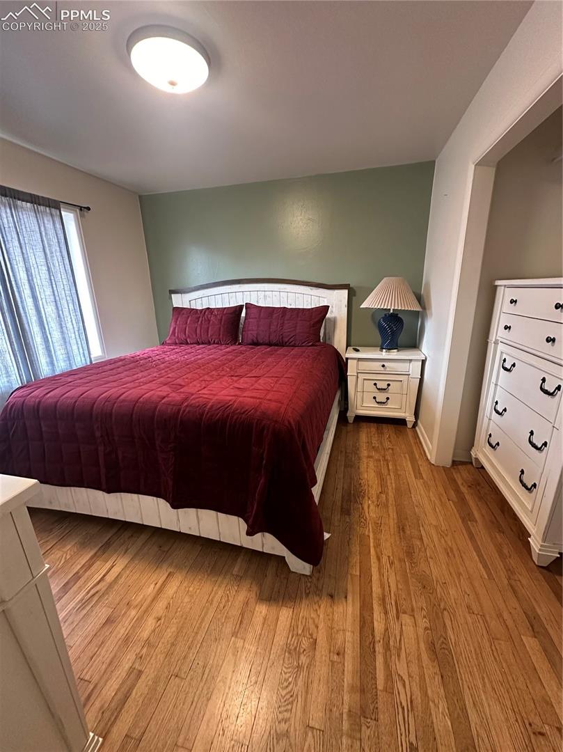 Bedroom with wood-type flooring