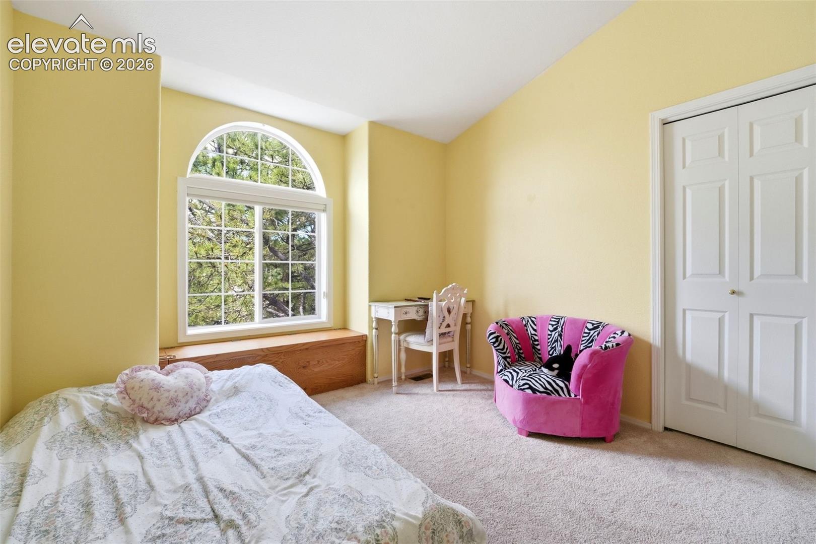 Arched window with gridded panes and integrated window seat