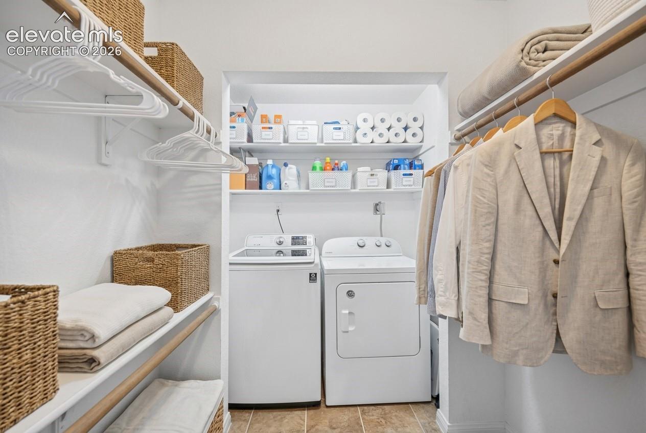 Laundry area with full-size washer and dryer, adjacent to closet storage