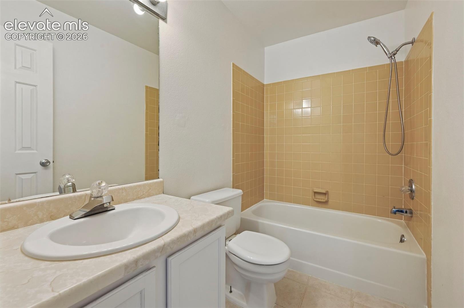 White bathroom vanity with an integrated sink and chrome faucet, set against a full-width mirror