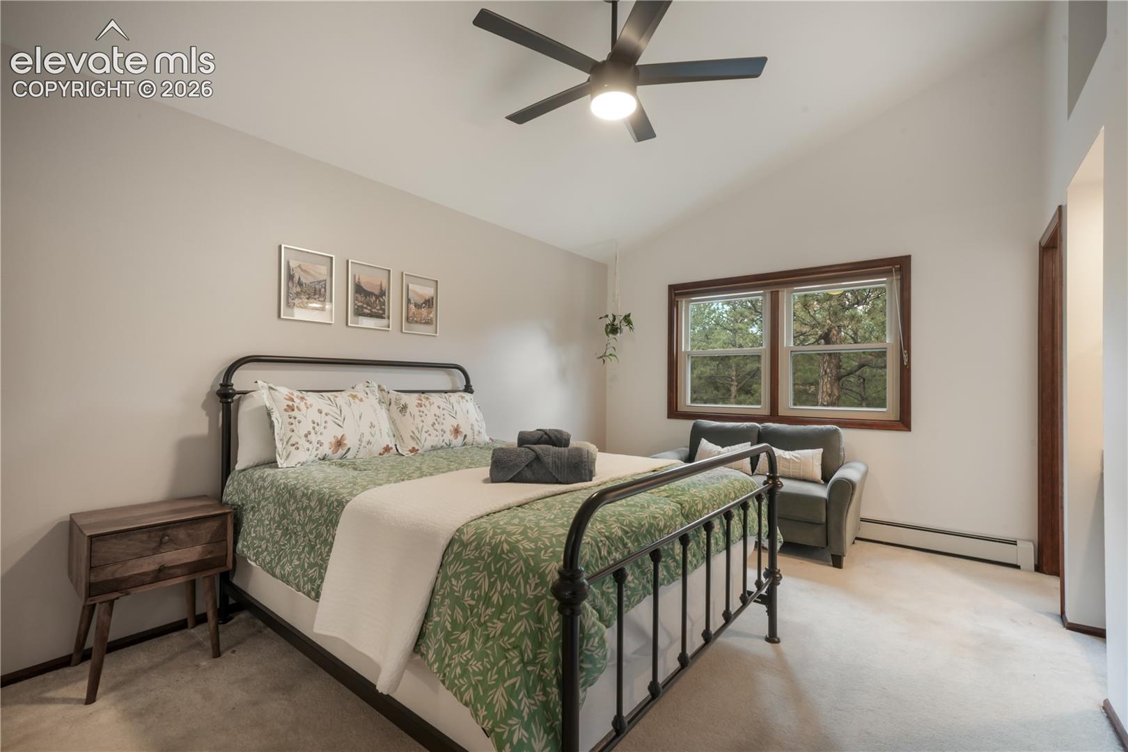 Upper level bedroom with vaulted ceiling