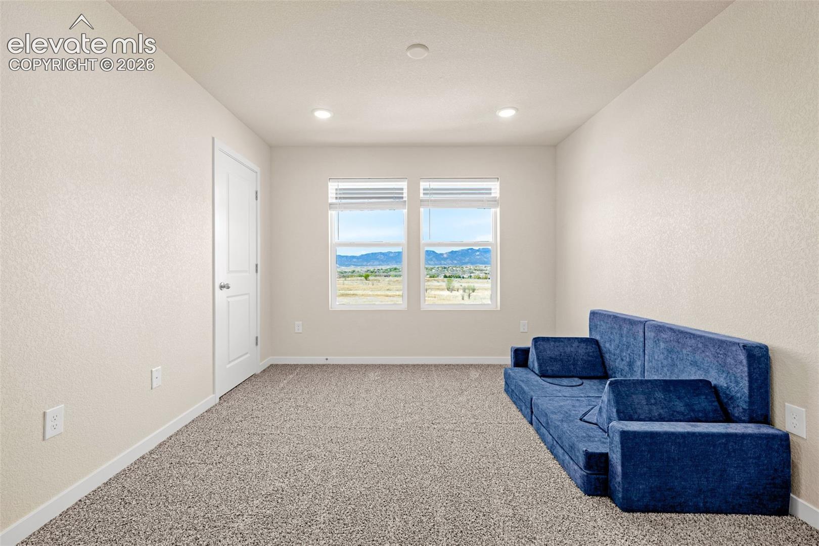 Recessed lighting, neutral wall tones, white trim, and carpet flooring