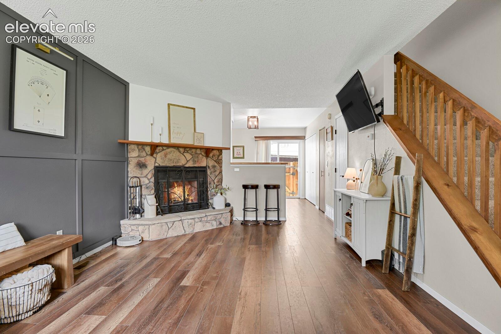 Stone fireplace with a wood mantel