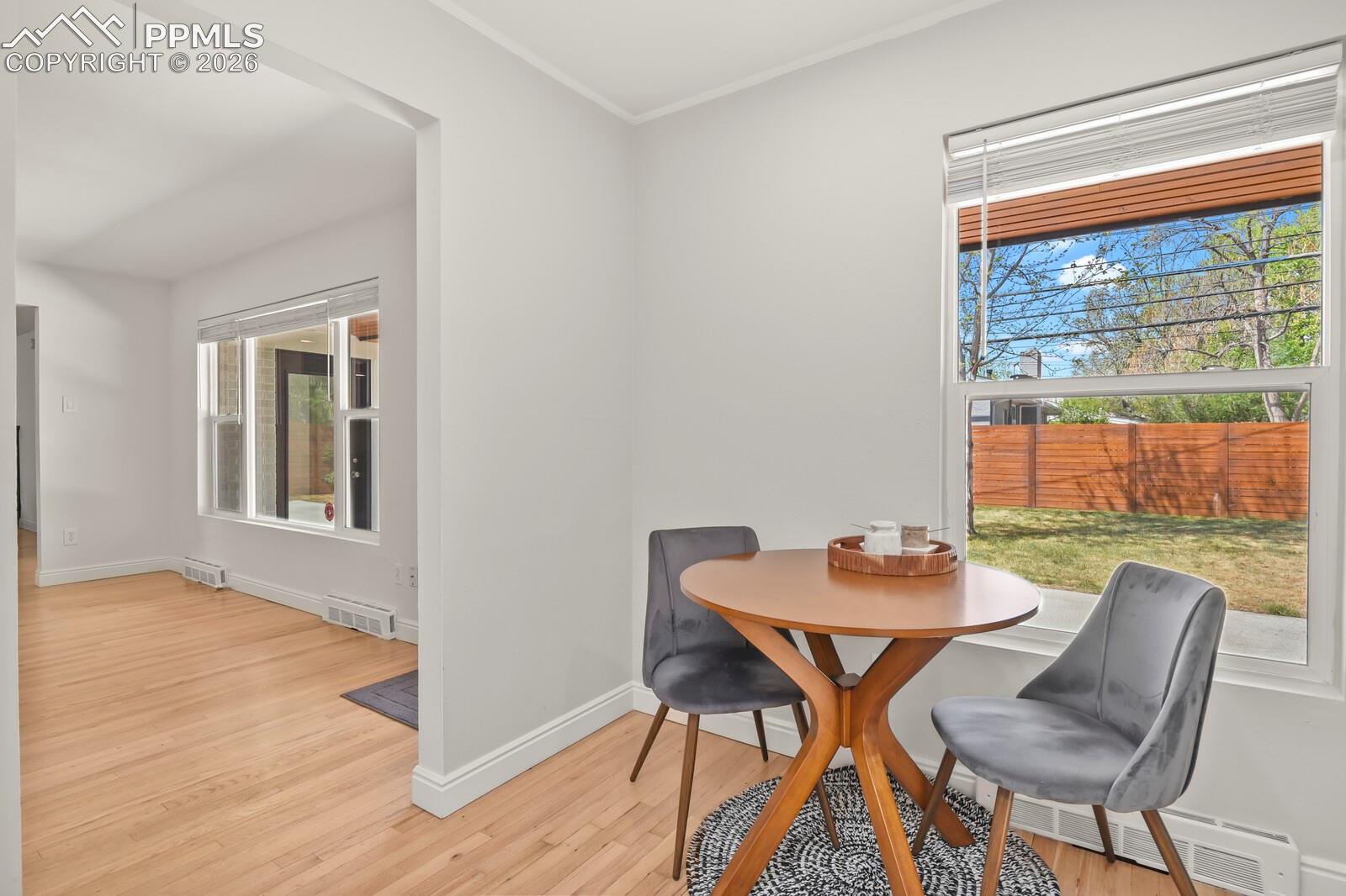 Breakfast nook, hardwood flooring extends throughout the bright interior