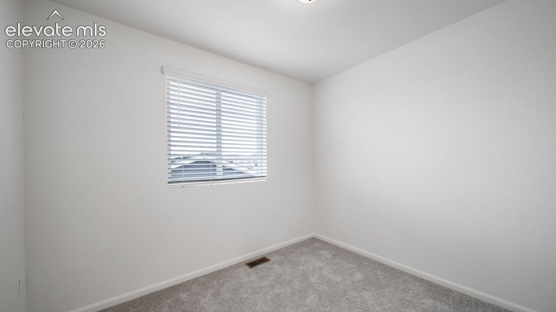 Recessed lighting, light gray carpeting, and white window blinds
*photos of a model home*