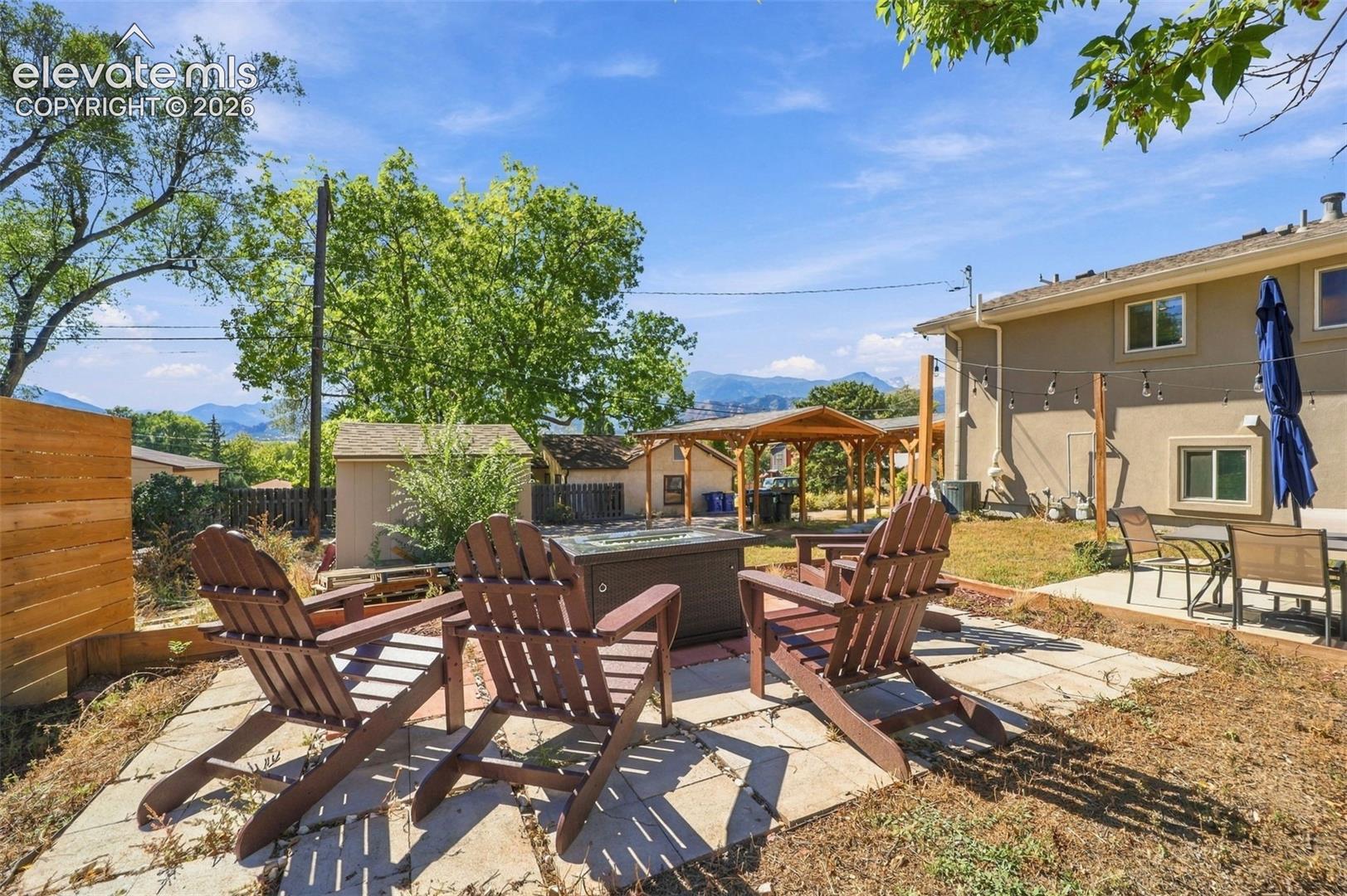 A gas fire pit in the back corner of the Back yard 