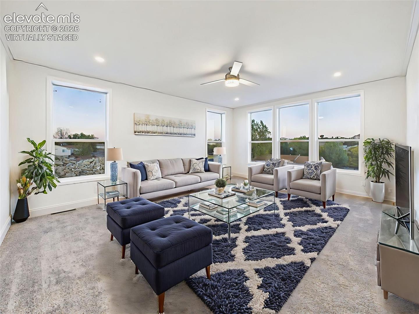Virtually Staged Living room with ceiling fan looking into kitchen