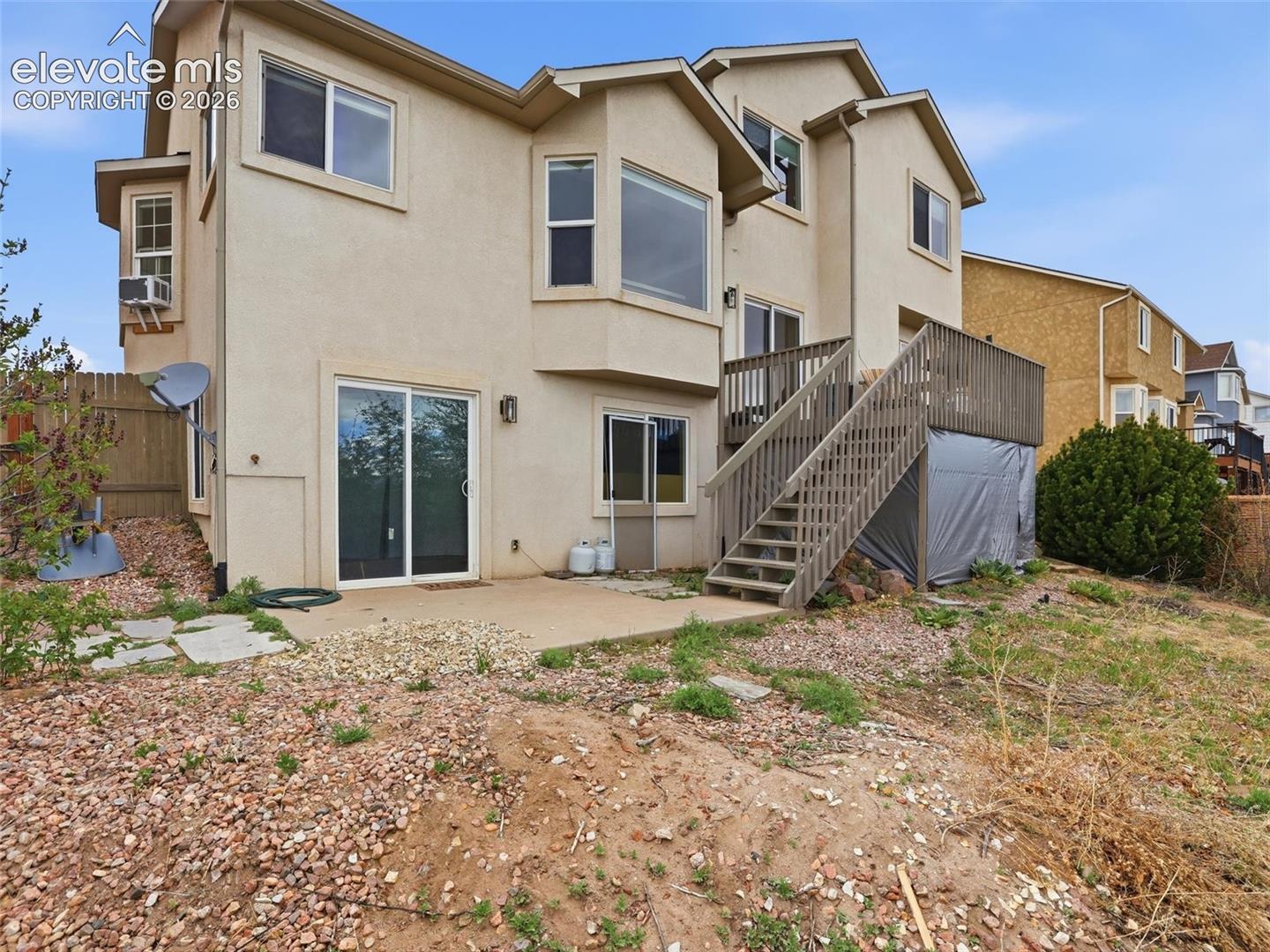 Multi-level stucco exterior with multiple window configurations