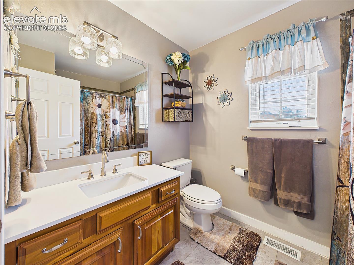 Updated hall bathroom features a modern vanity, stylish fixtures, and convenient access for guests and secondary bedrooms.