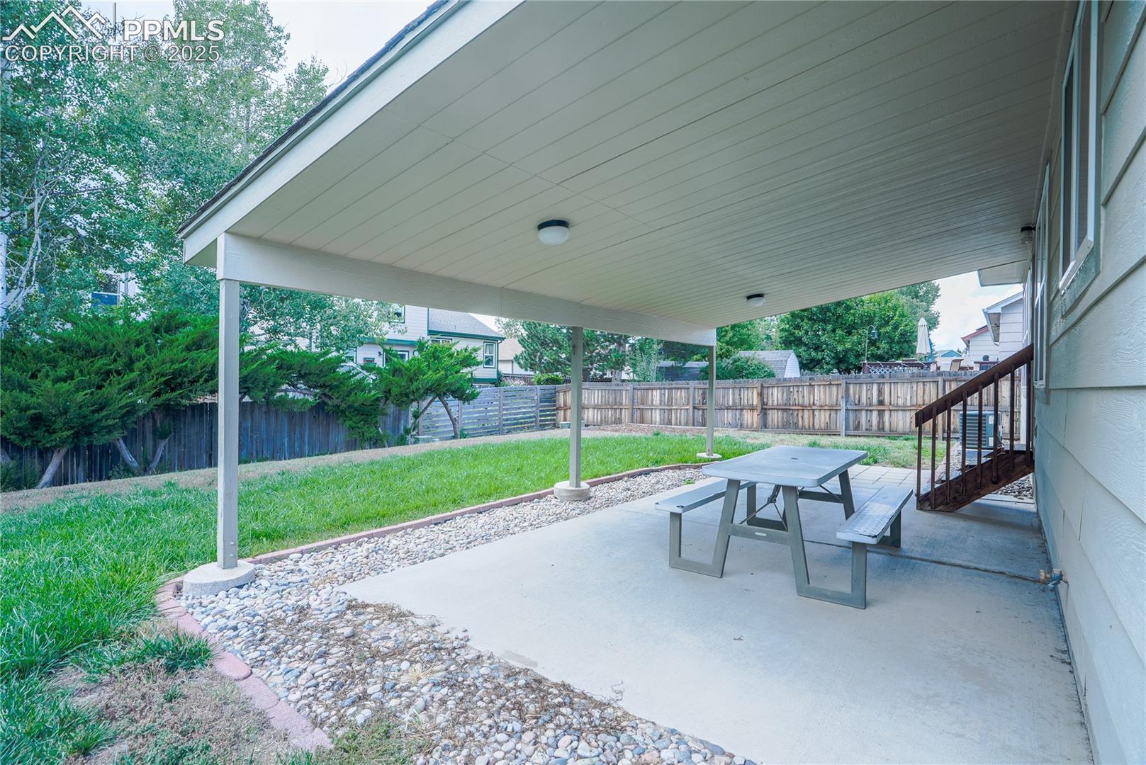 Fenced backyard featuring a patio area and outdoor dining space
