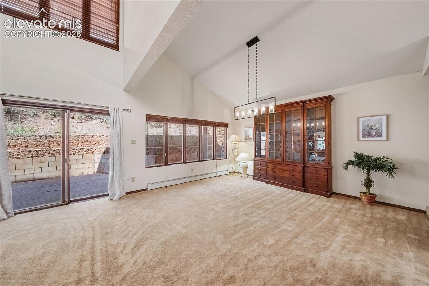 Spacious dining and living room combination with plenty of room for entertaining and gatherings, featuring a convenient walkout to enjoy the surrounding views and outdoor space.