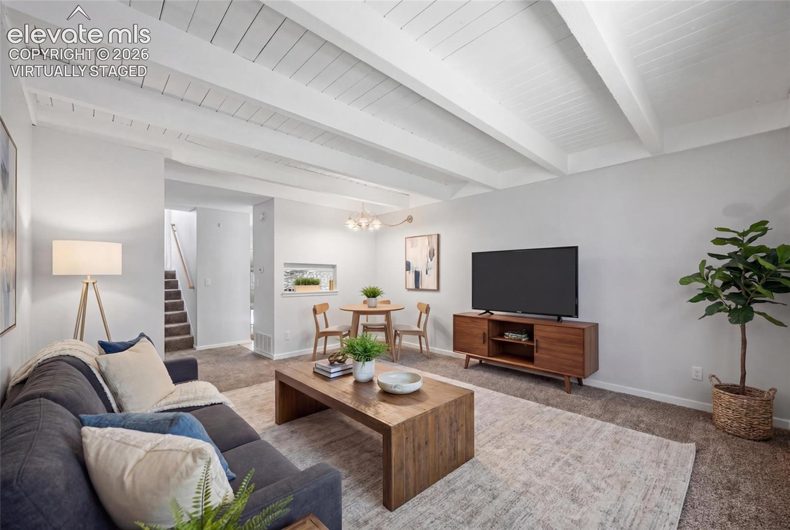 virtually staged Living room with dining area for a table. 