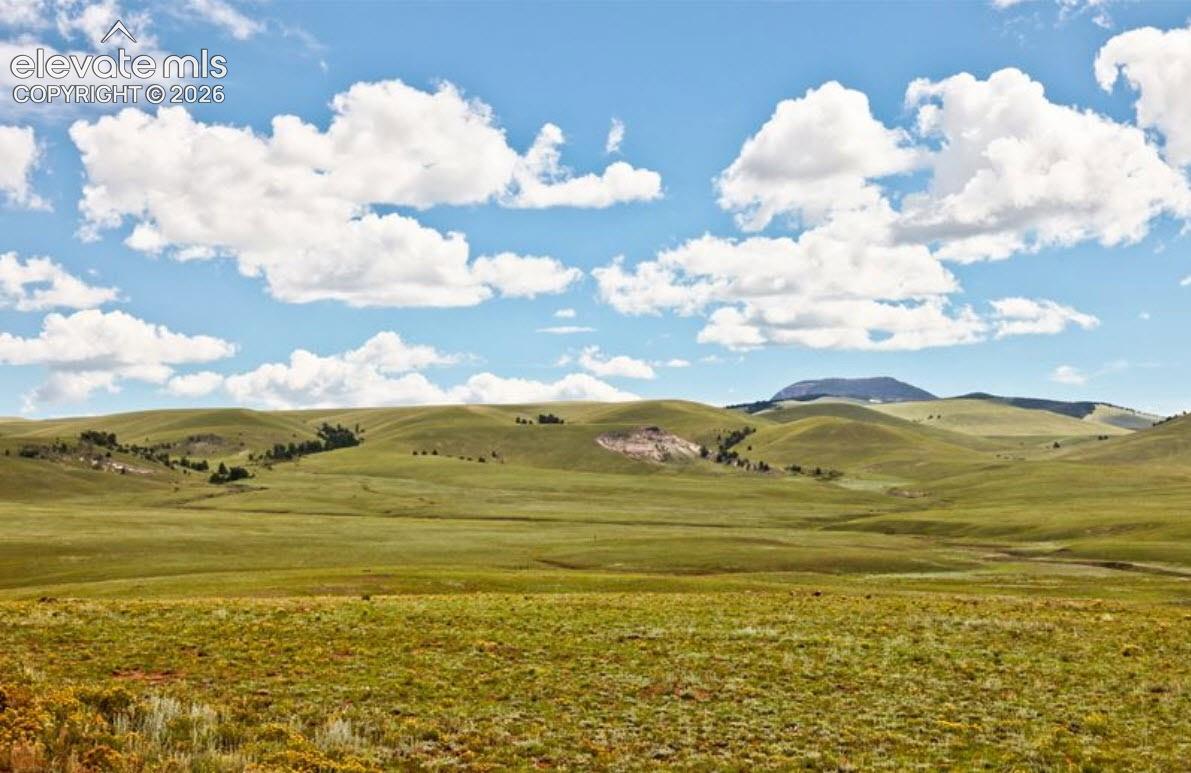 Expansive acreage featuring rolling terrain, natural grasslands, and mountain topography