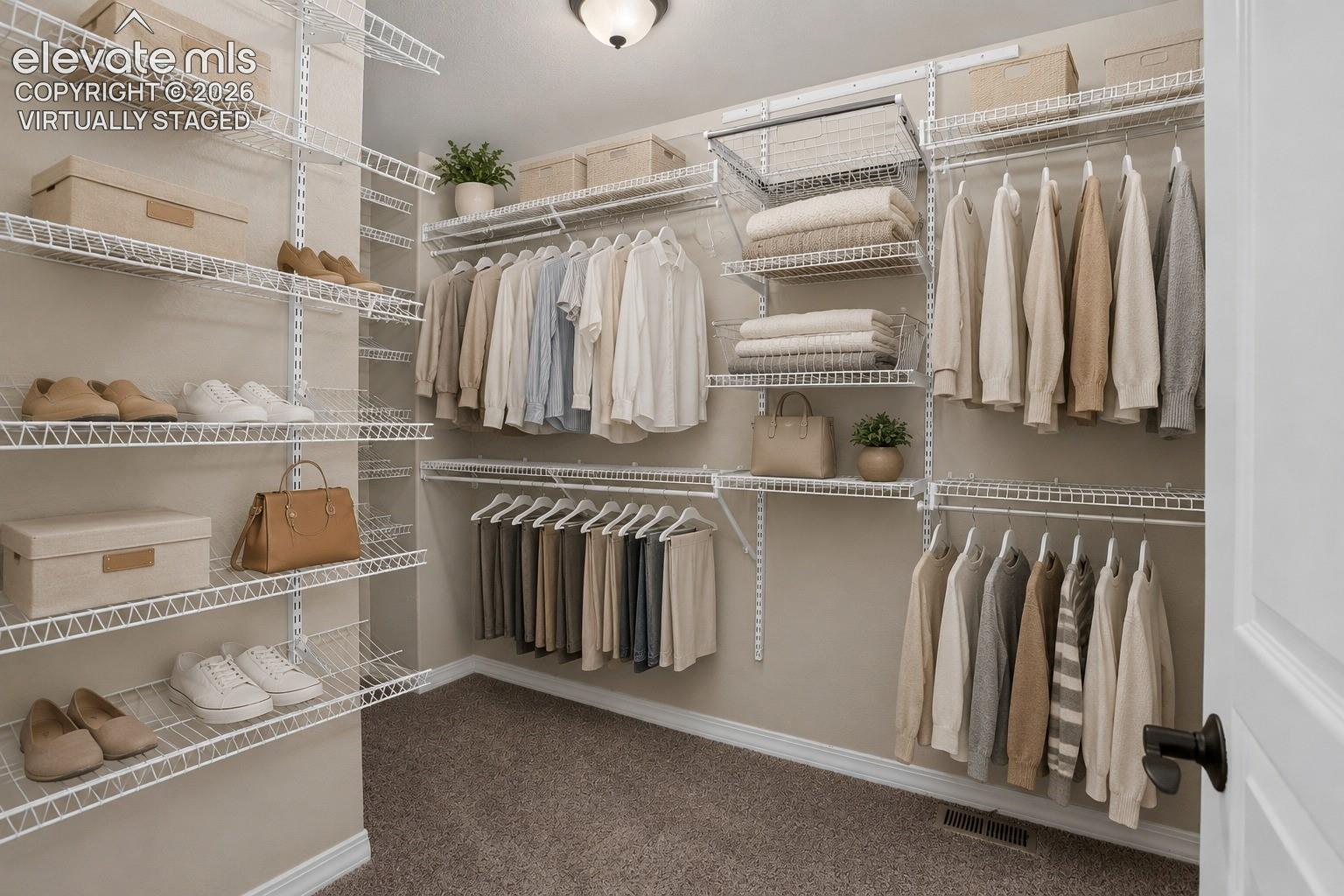 Virtually Staged - Custom wire shelving system, multiple hanging rods, integrated shoe racks, neutral wall paint, and textured carpeting