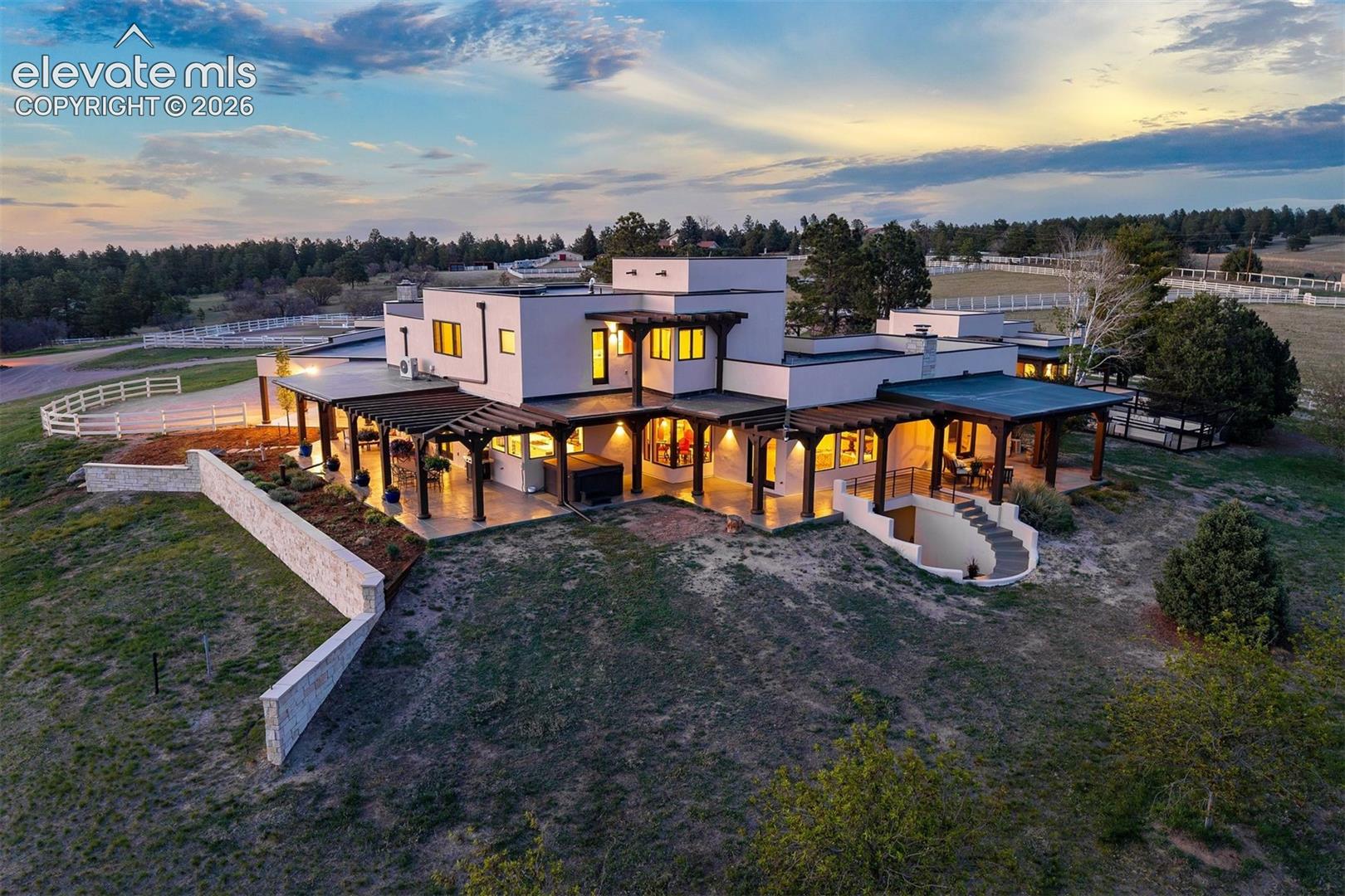 Rear overview showing the expansive patio and architectural detail of the home.