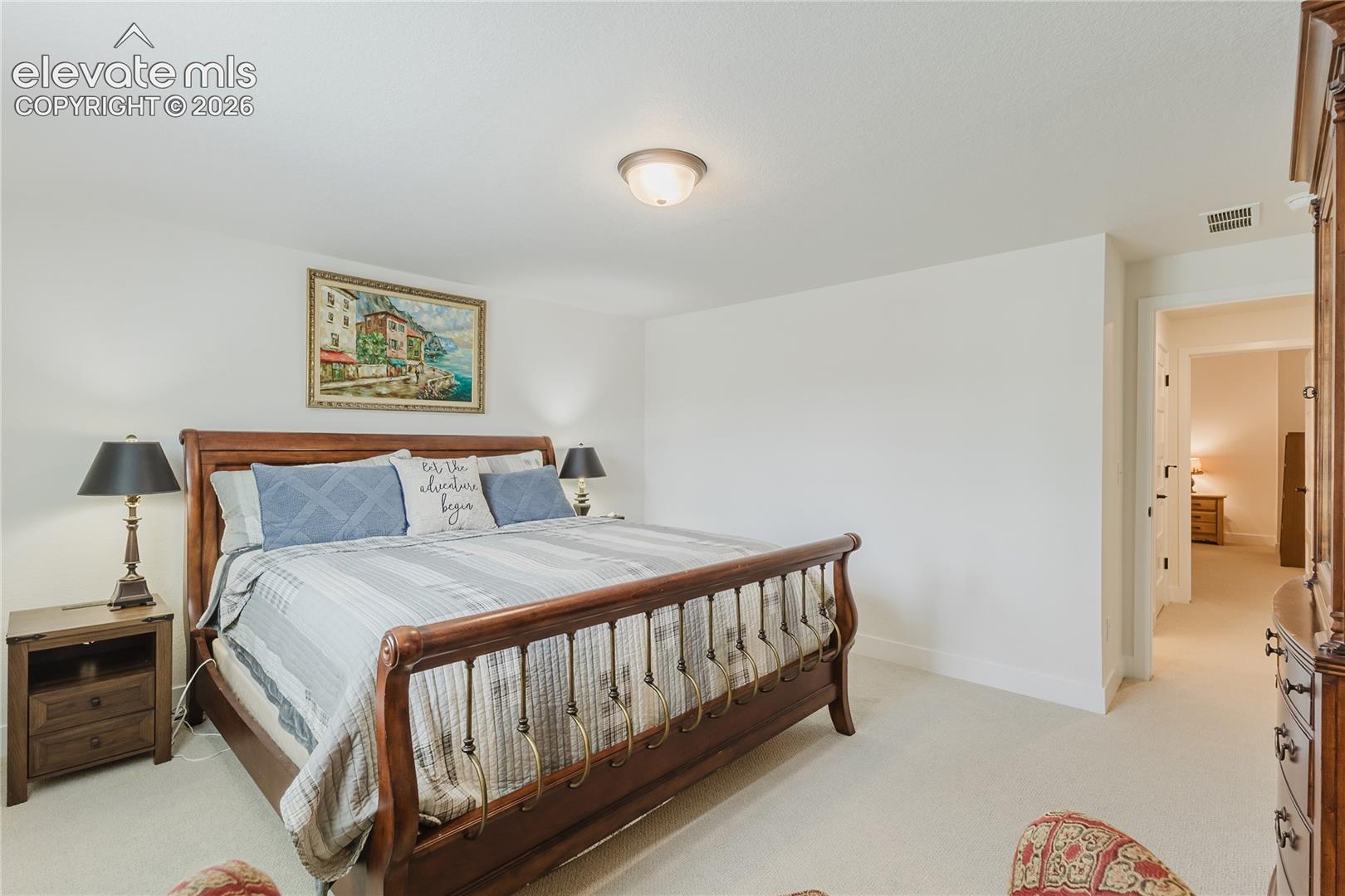 Bedroom in the lower level with plantation shutters and a walk in closet