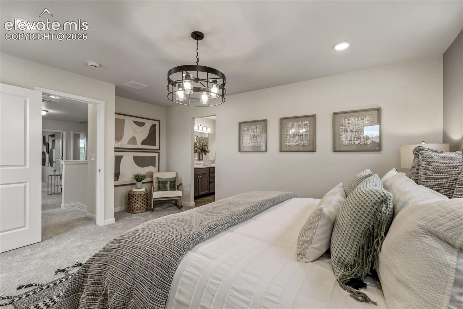 Carpeted flooring, recessed lighting, and a dark metal chandelier with exposed bulbs