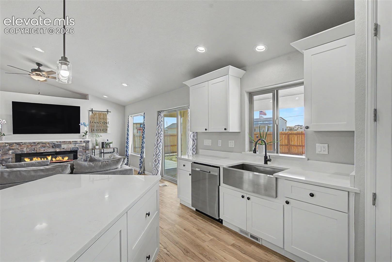Open-concept kitchen with white cabinetry and light-toned countertops